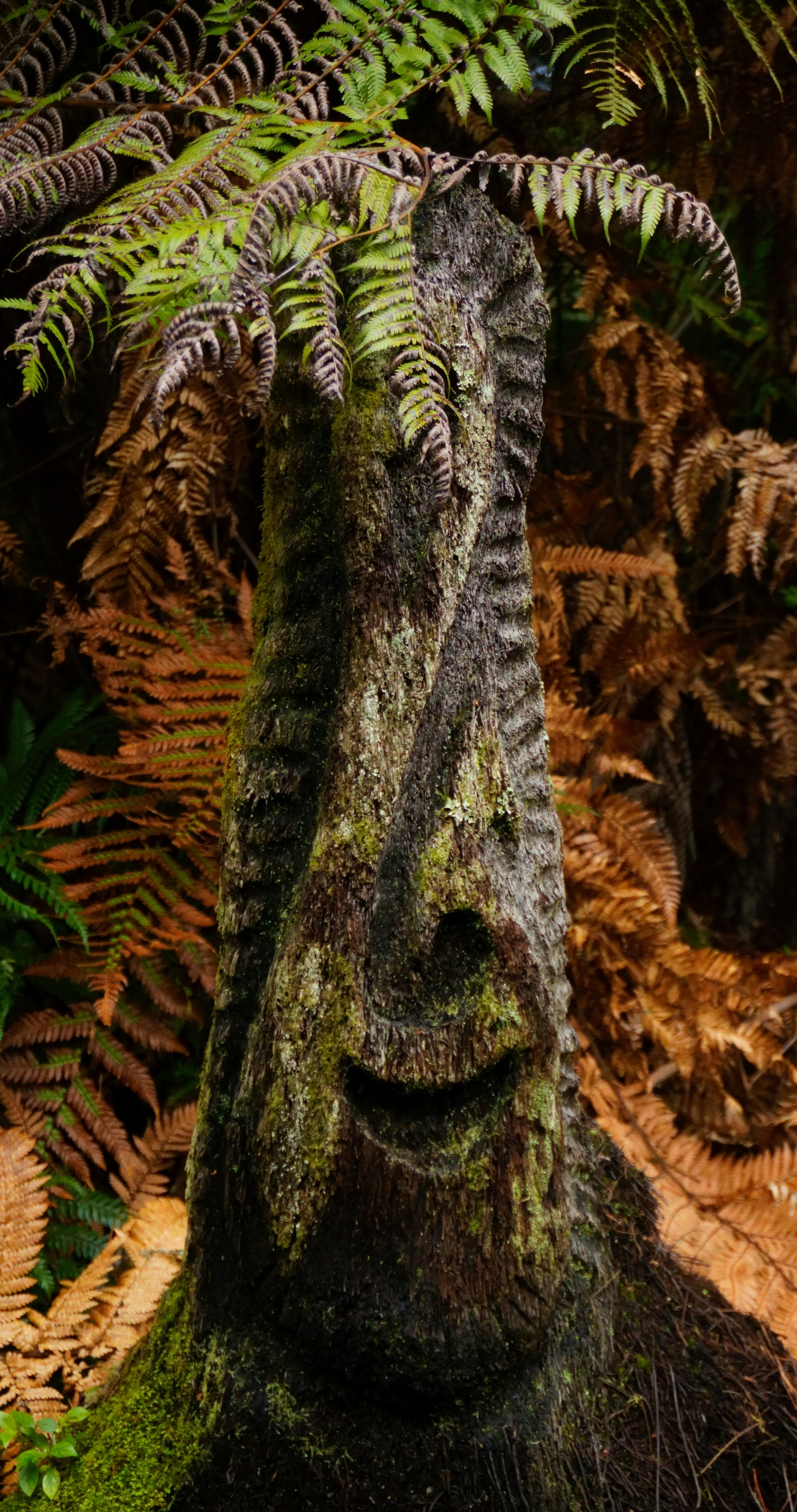 A wooden carving with a smiling face.