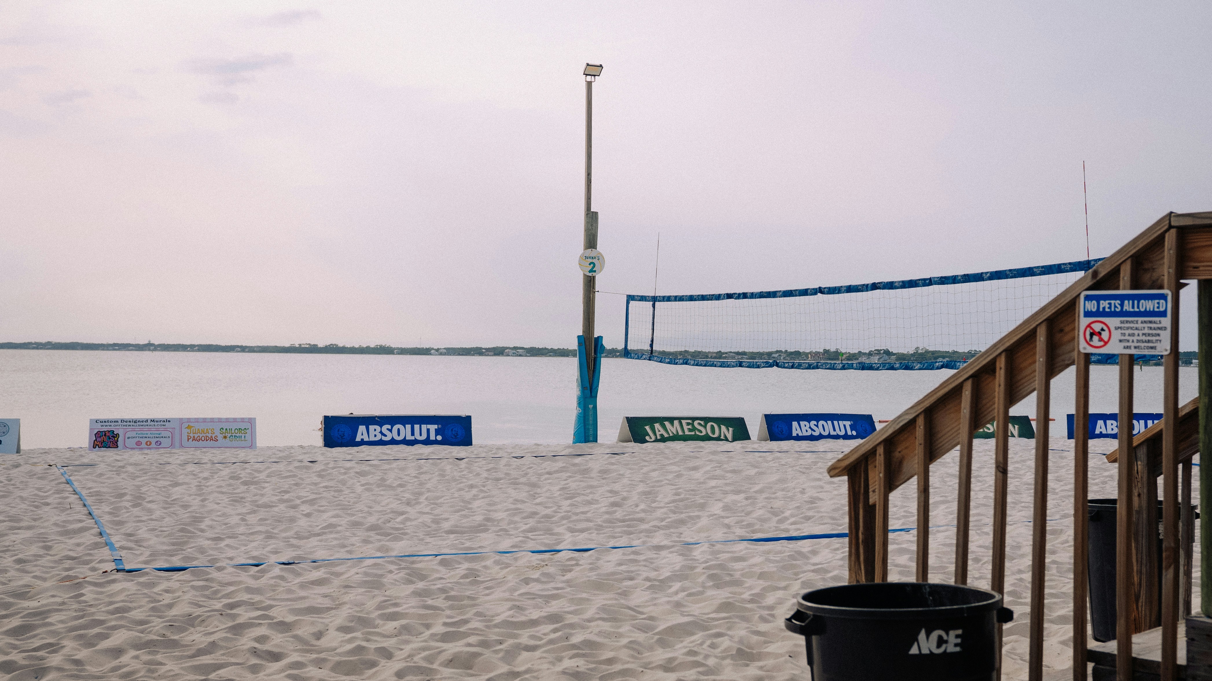 Beach volleyball court with a serene ocean view.