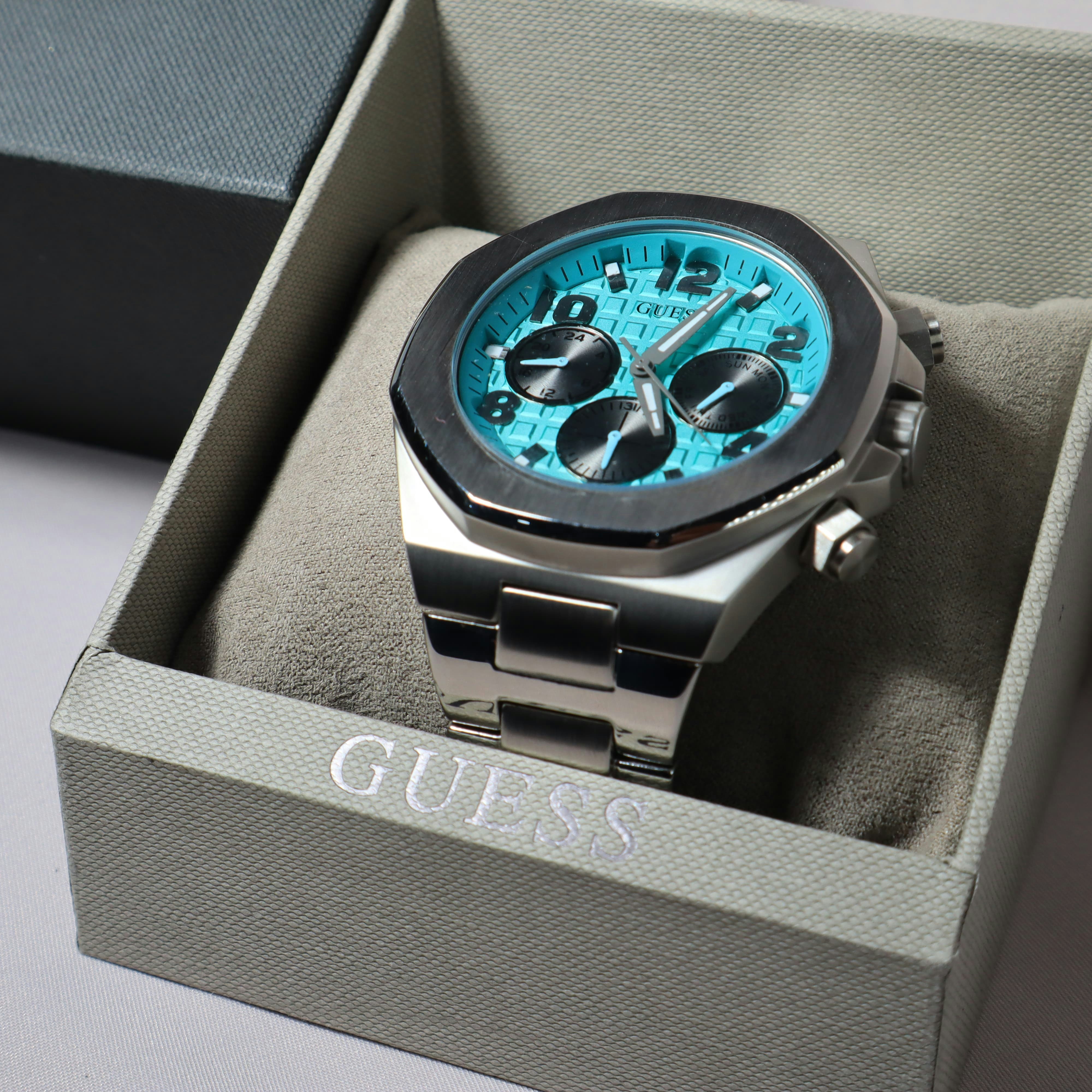 A guess watch sits inside its display box.