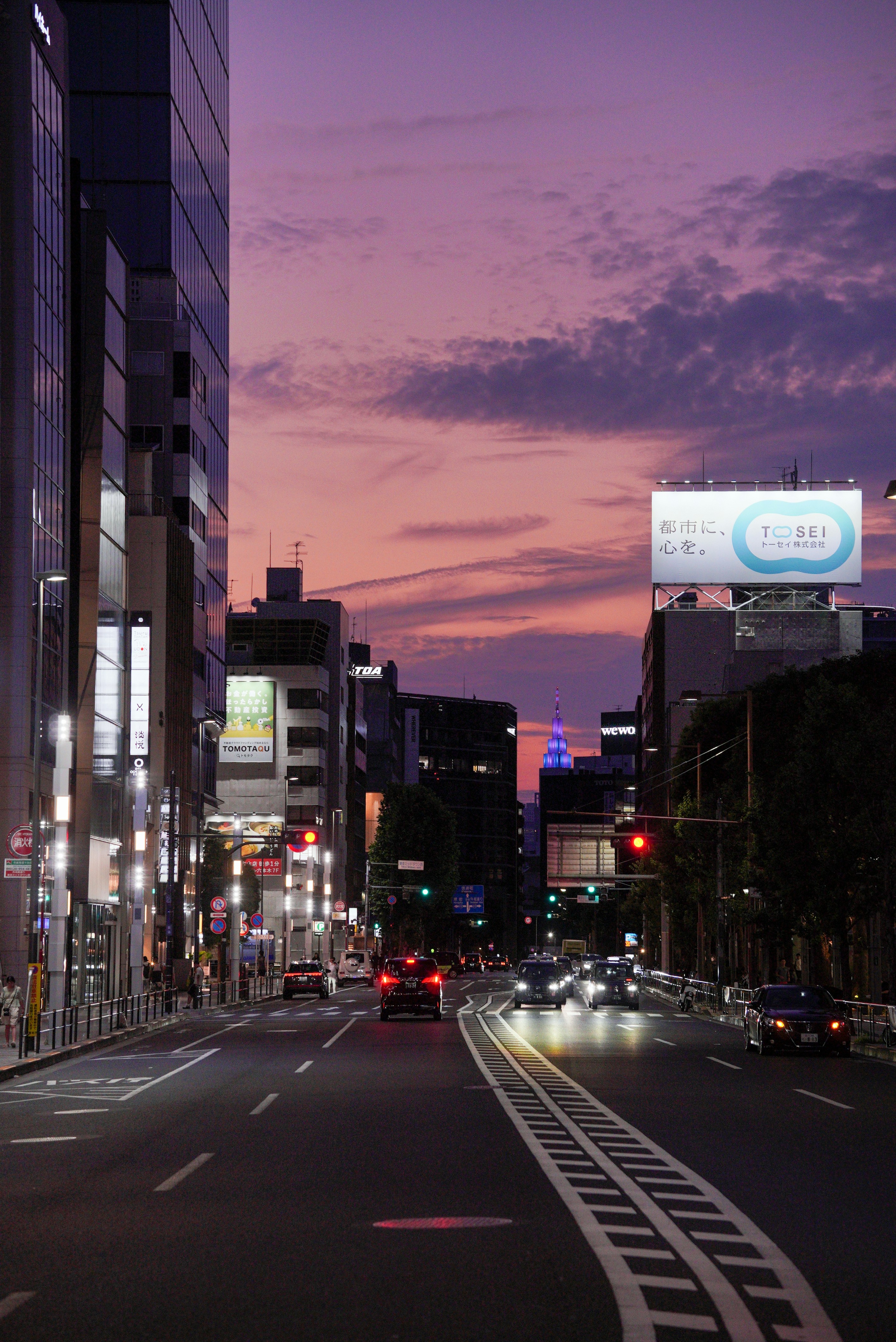 City street at dusk with a purple sky.