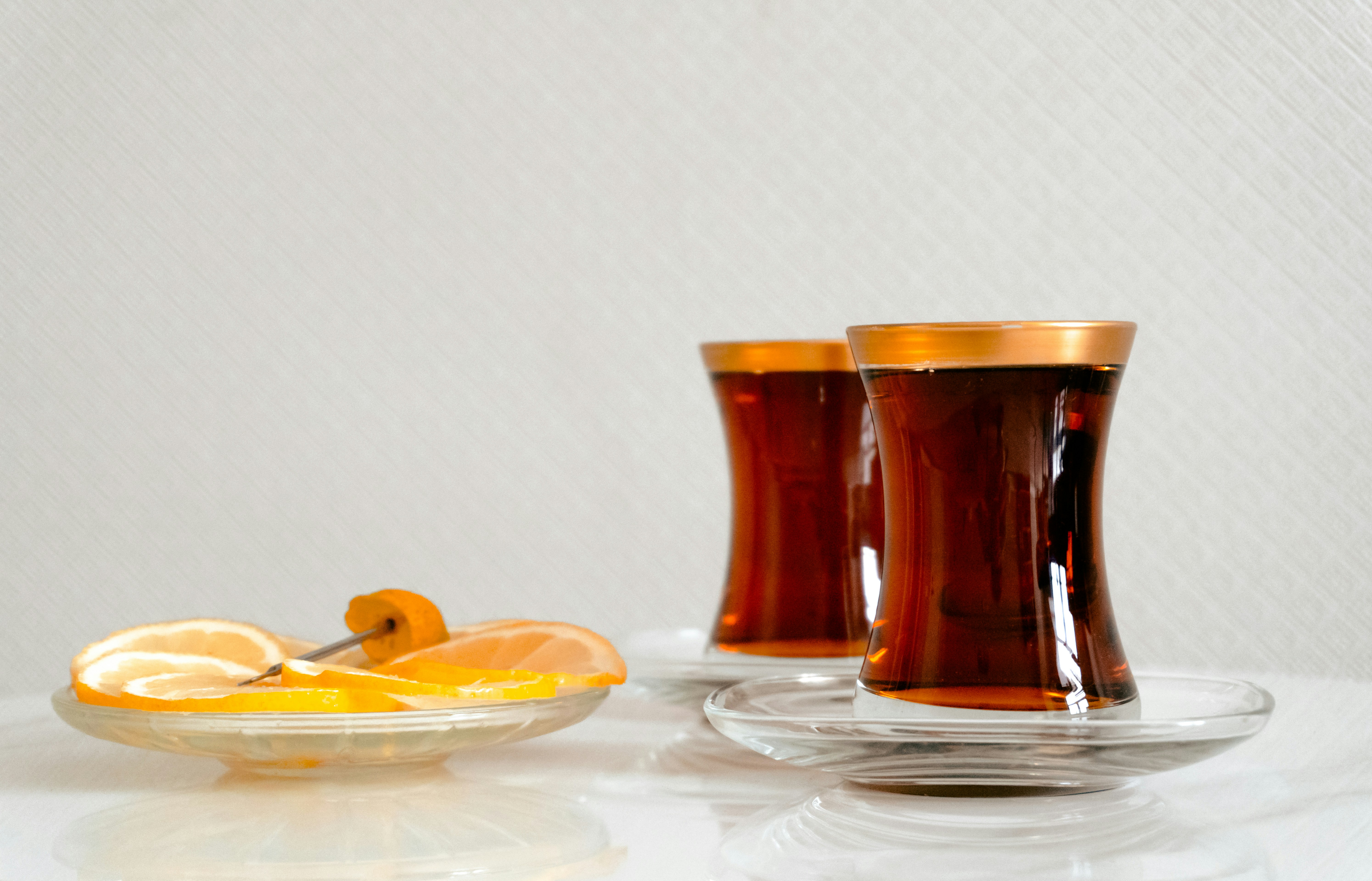 Two cups of tea with lemon slices.