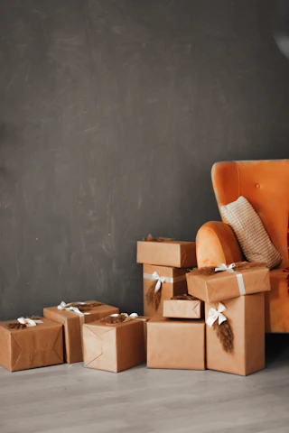 Wrapped gifts sit beside an orange chair.
