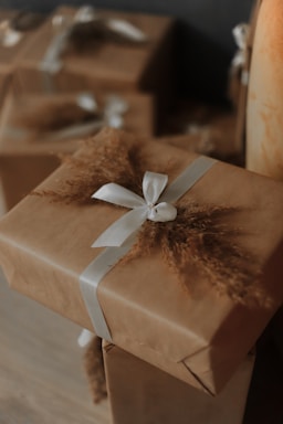 Gifts wrapped in brown paper with white ribbons.