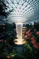 A stunning waterfall cascades in a glass dome.
