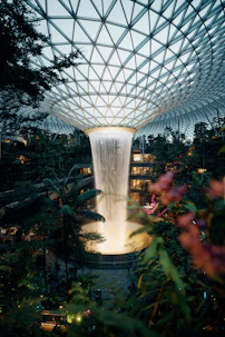 A stunning waterfall cascades in a glass dome.
