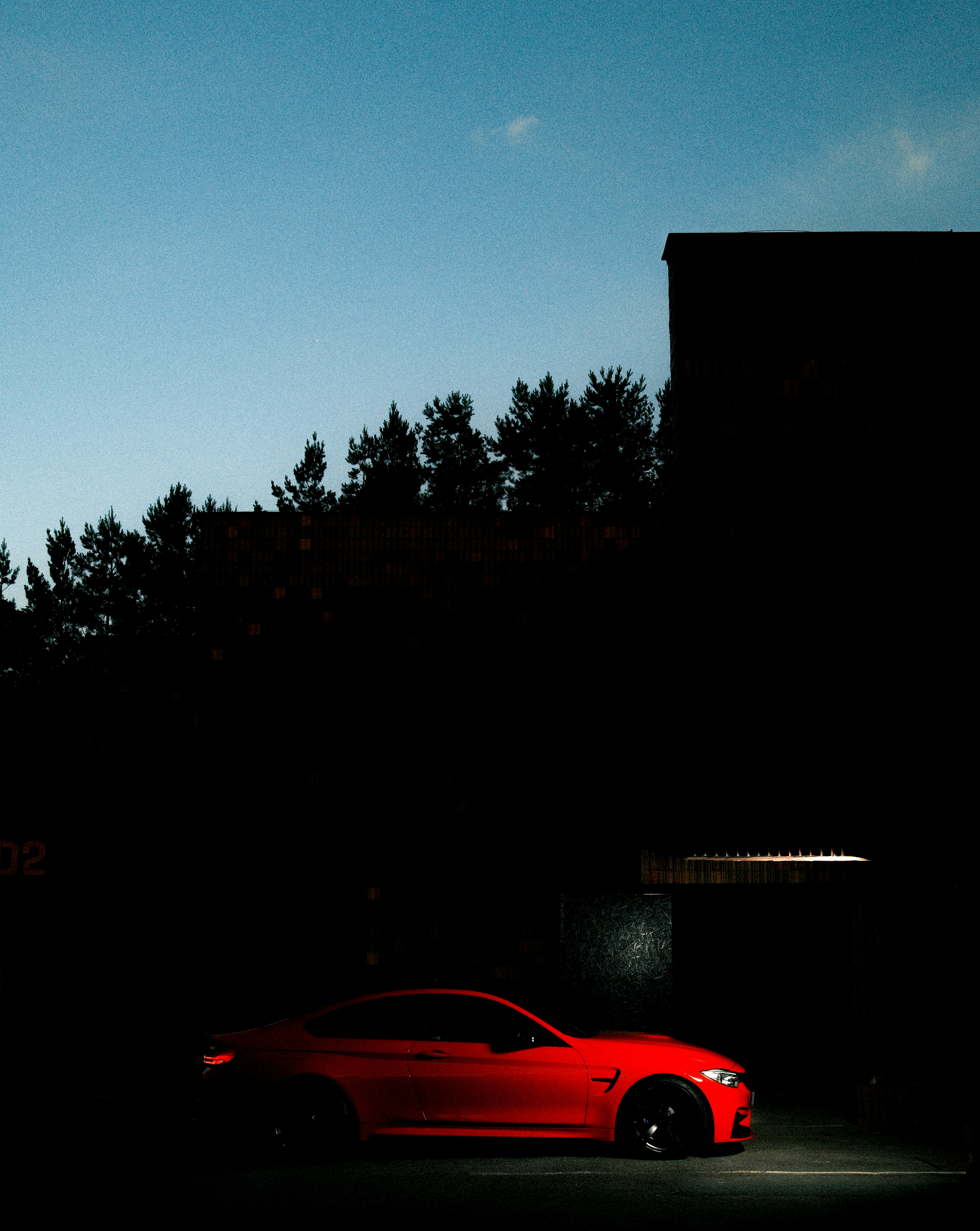 A red car is driving in the shadow. photo – Free Car Image on Unsplash