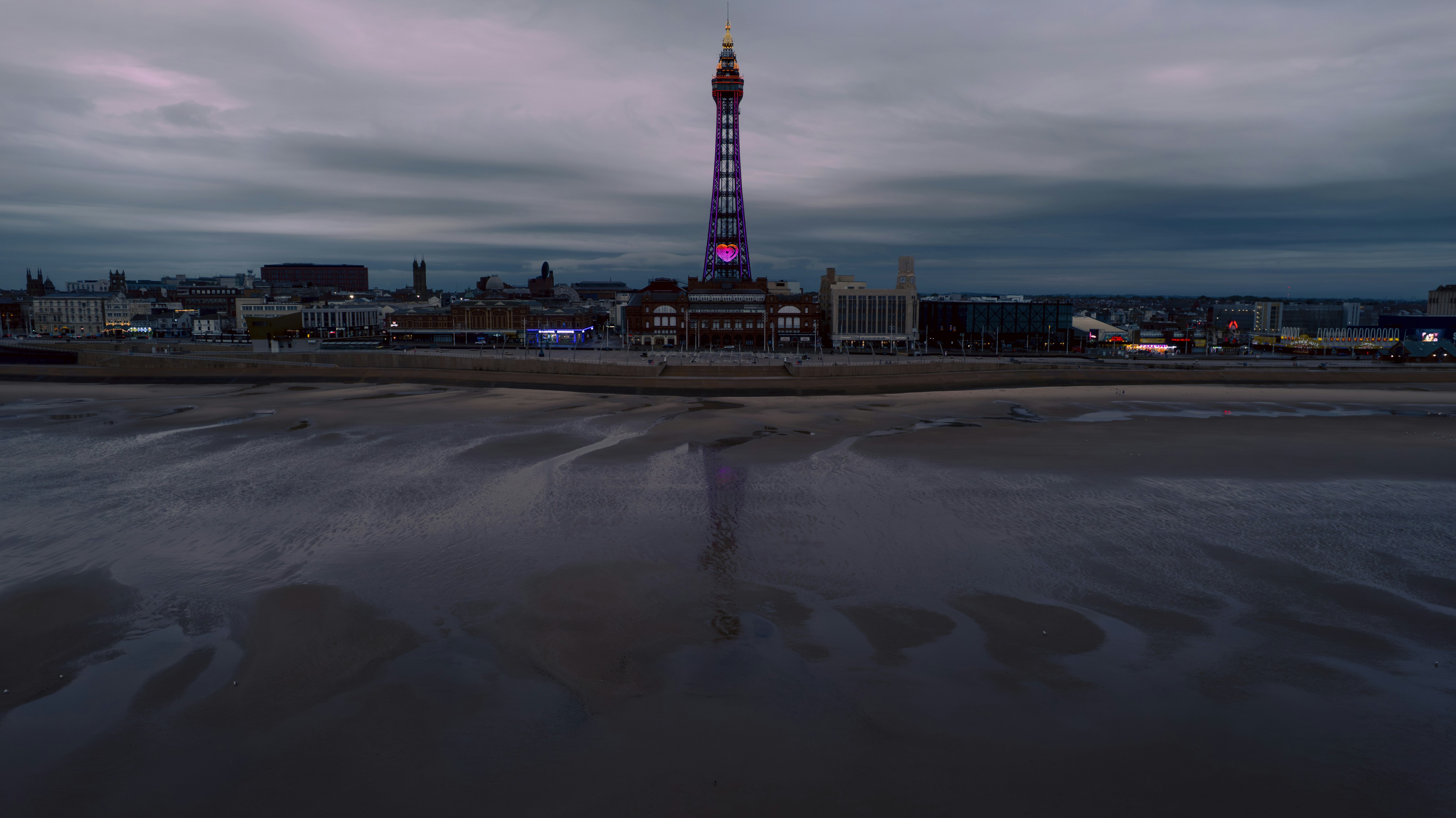 The blackpool tower stands tall over the beach.