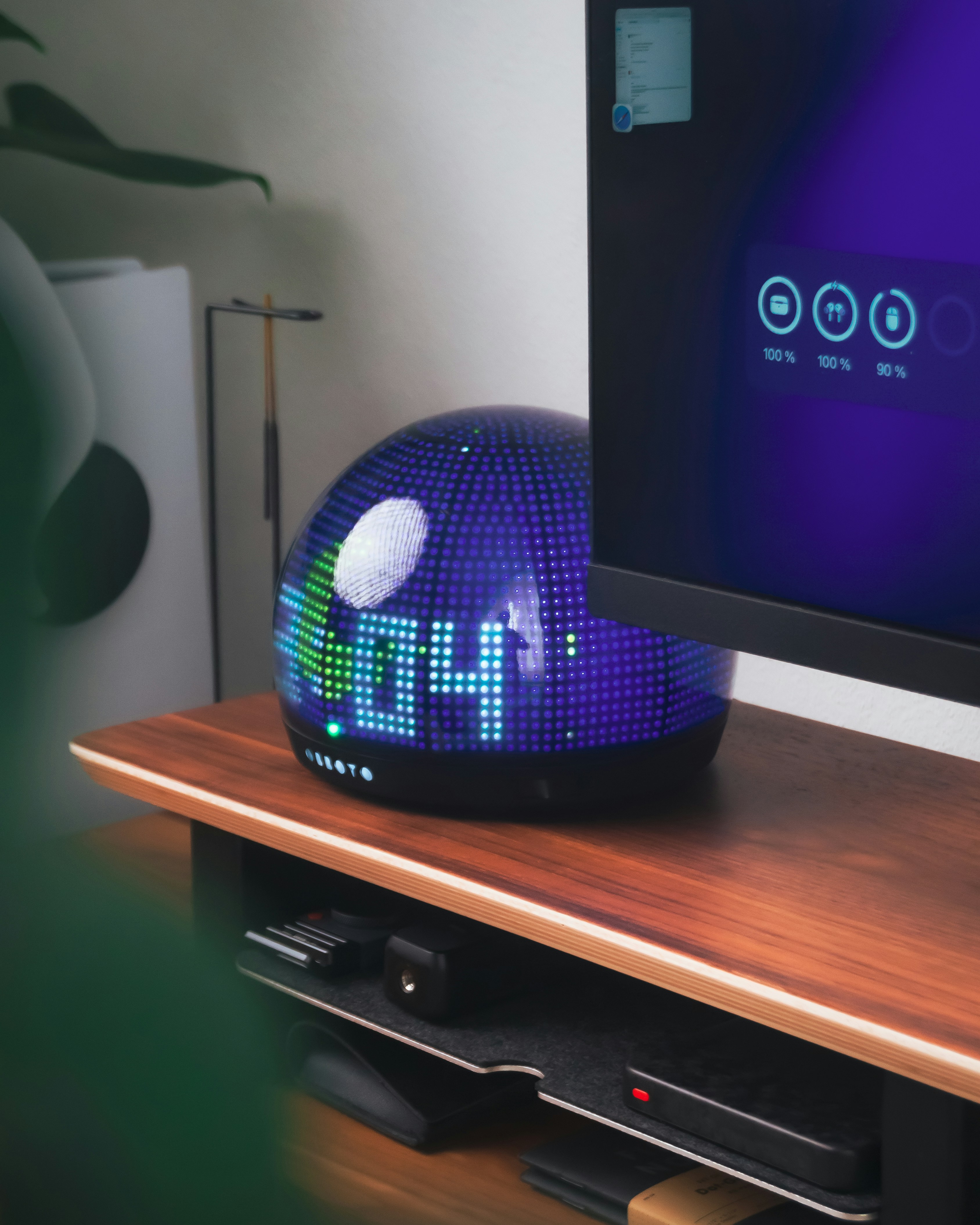 A digital clock sits on a wooden shelf.
