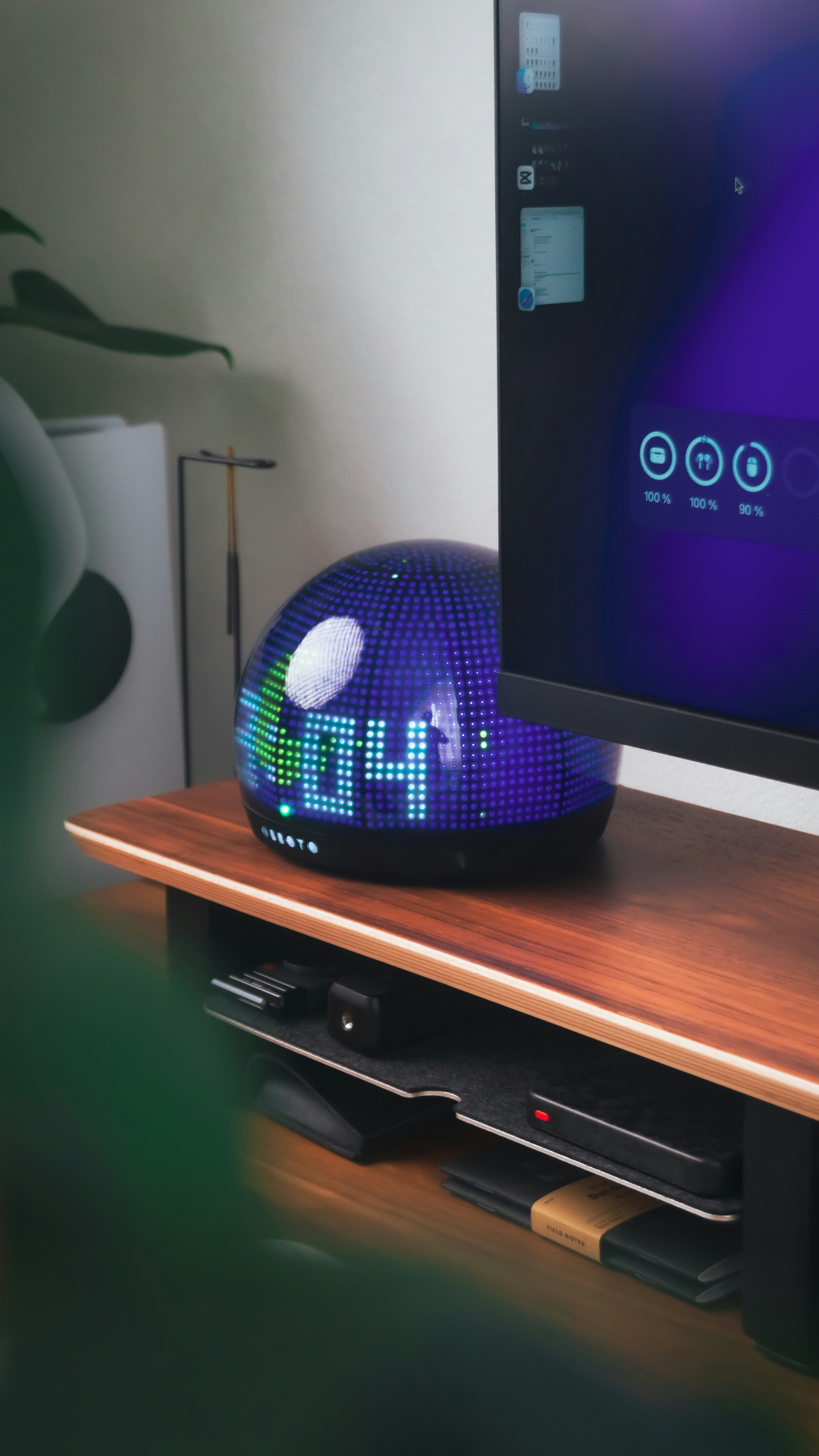 A futuristic clock sits near a computer monitor