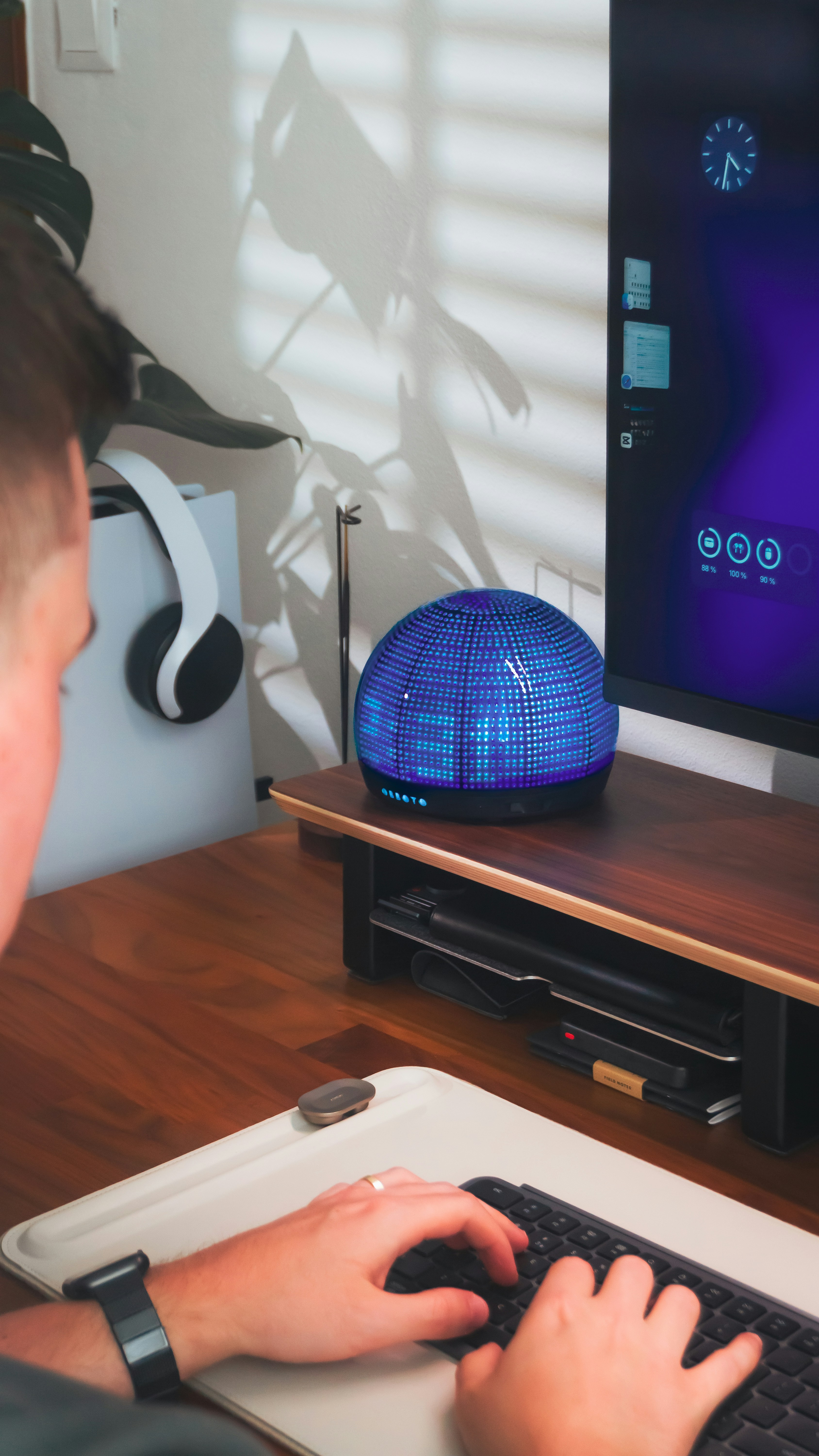Man is working on his computer at his desk.