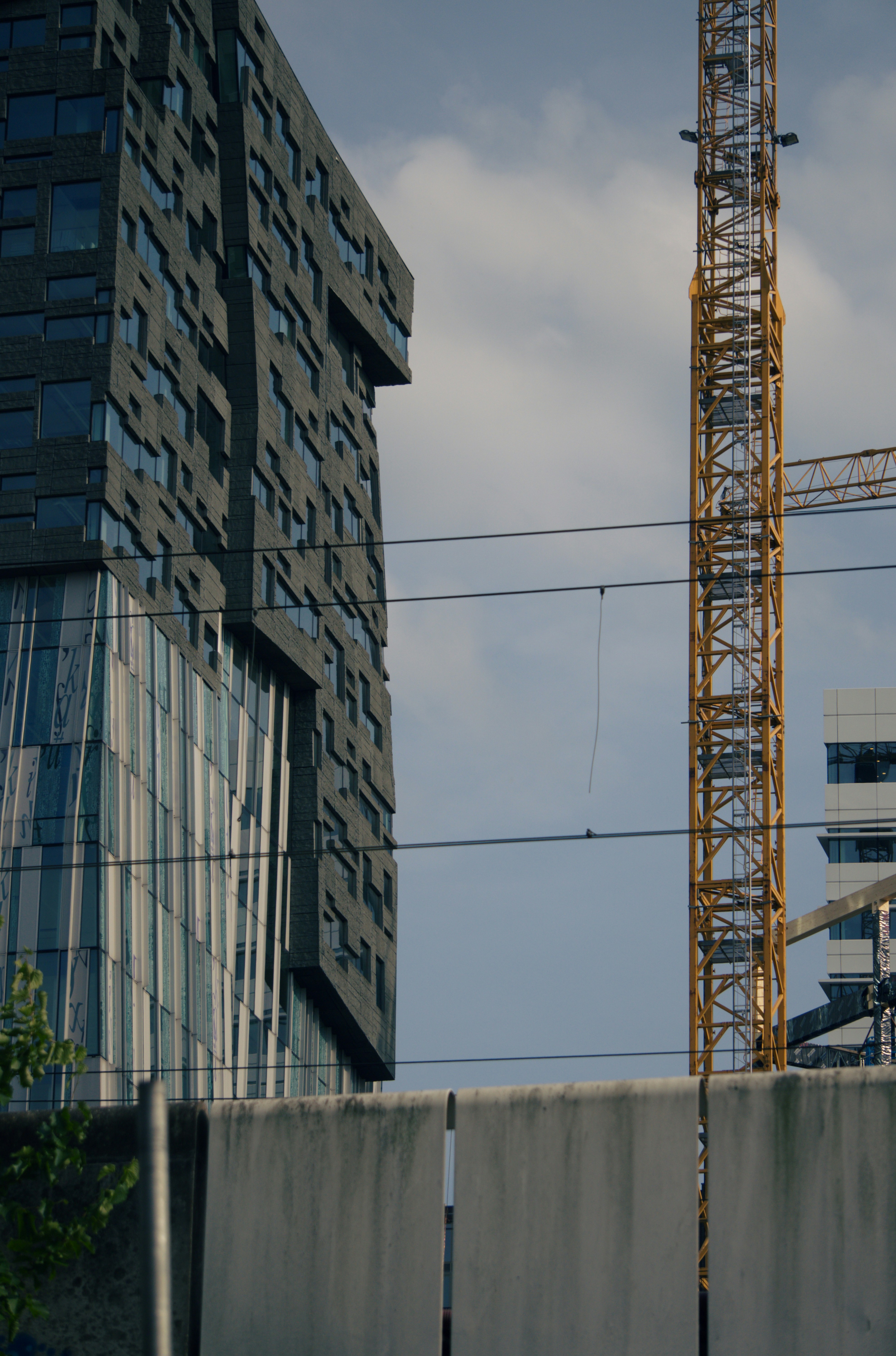 Skyscrapers stand tall near a construction crane.