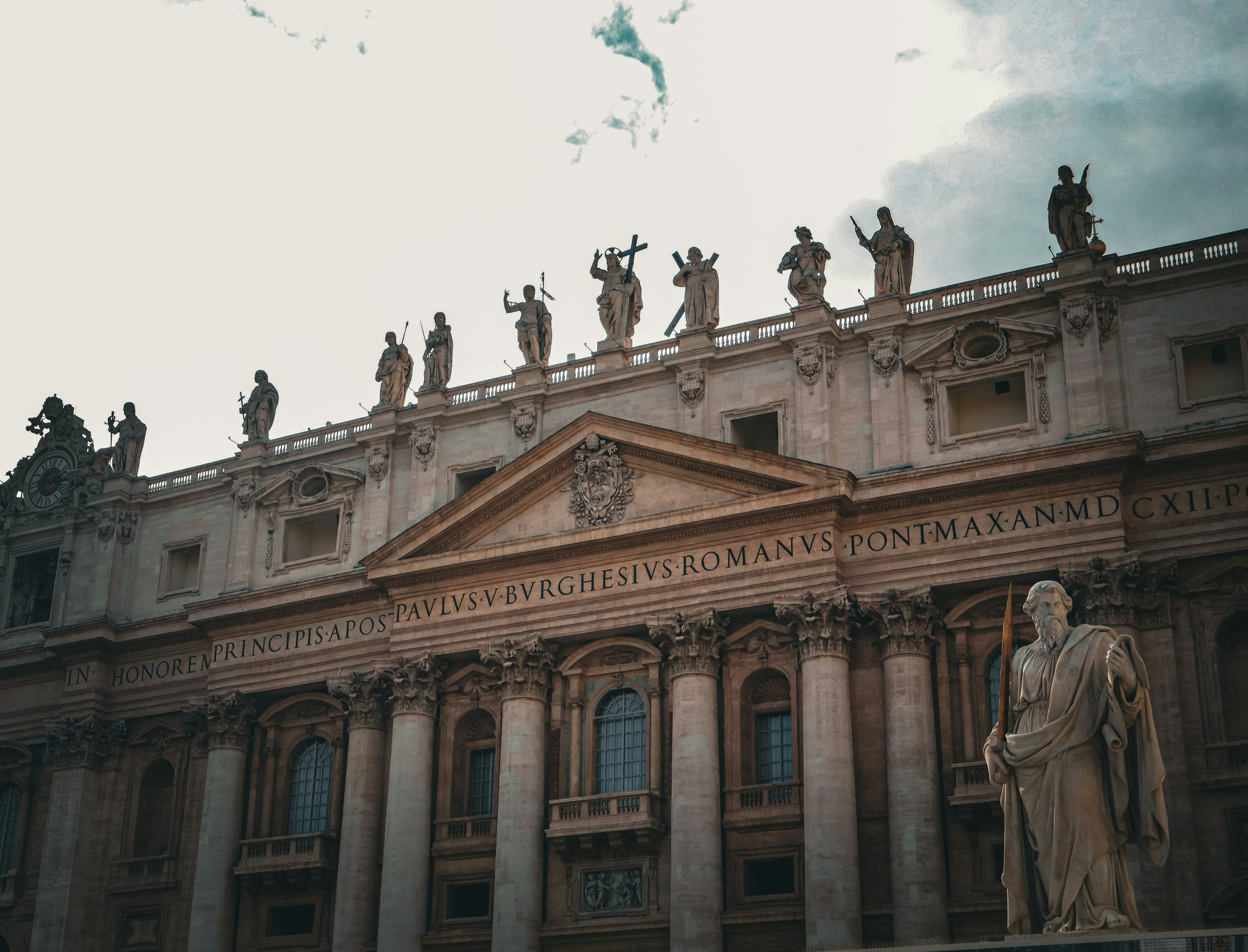 Statues adorn the front of a grand building.