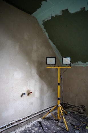 A construction site with lighting and new plaster.