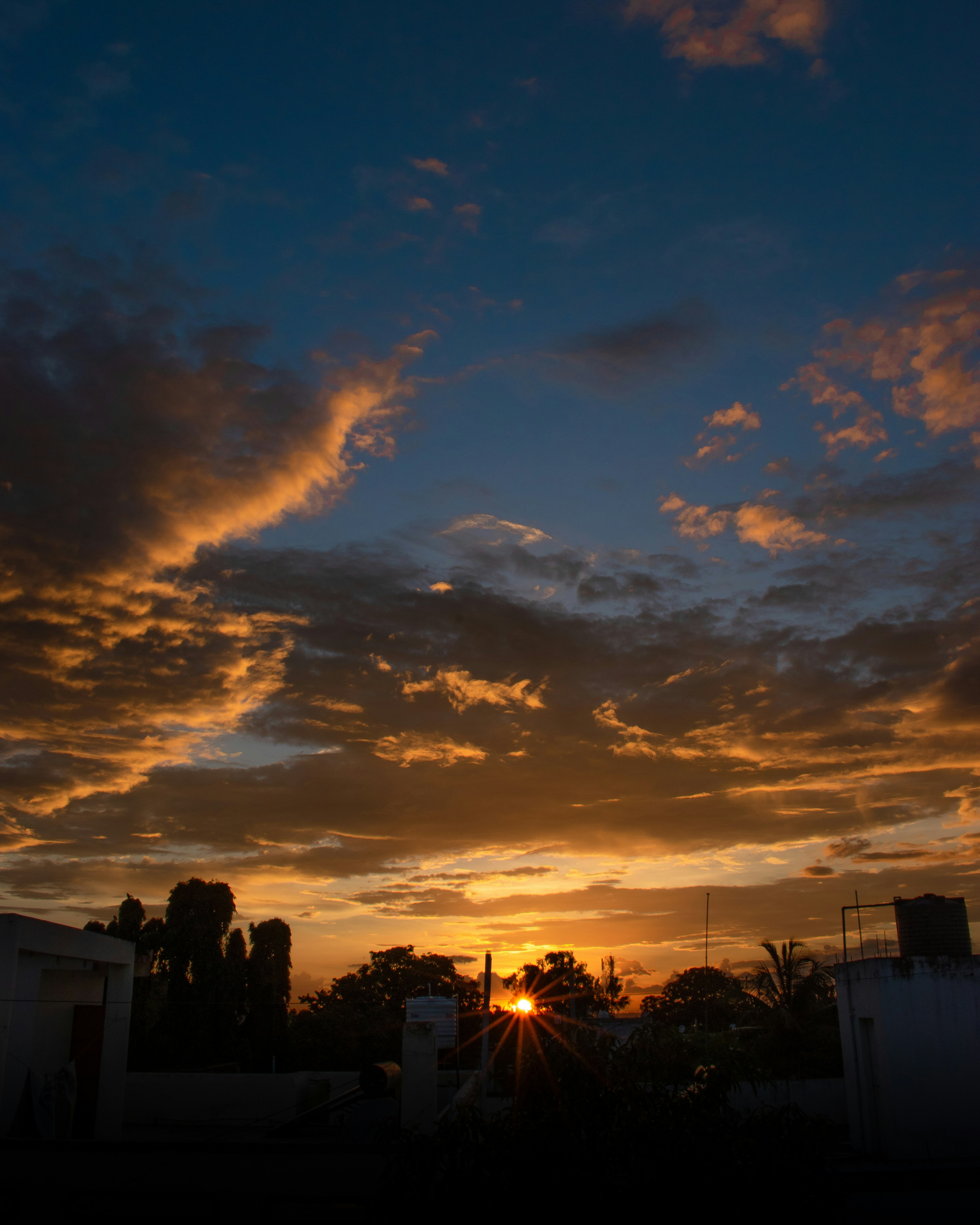 Golden sunset over the silhouetted horizon.