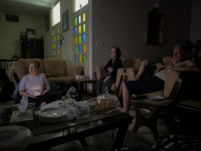 People relax in a dimly lit living room.