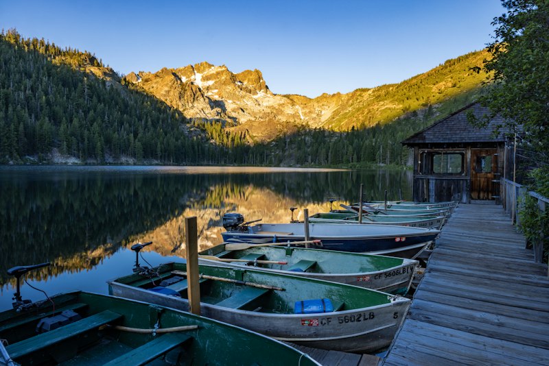 Boats on scenic lake at sunrise