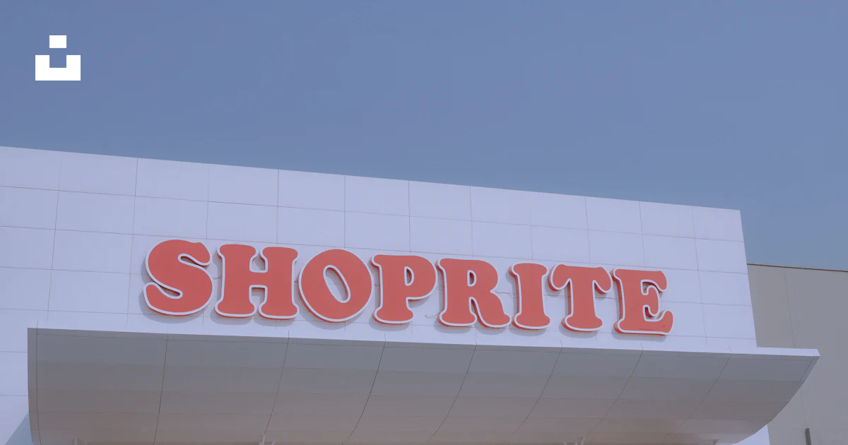 Shoprite Sign In Shoprite sign on a building, beneath blue sky. photo – Free Building ...