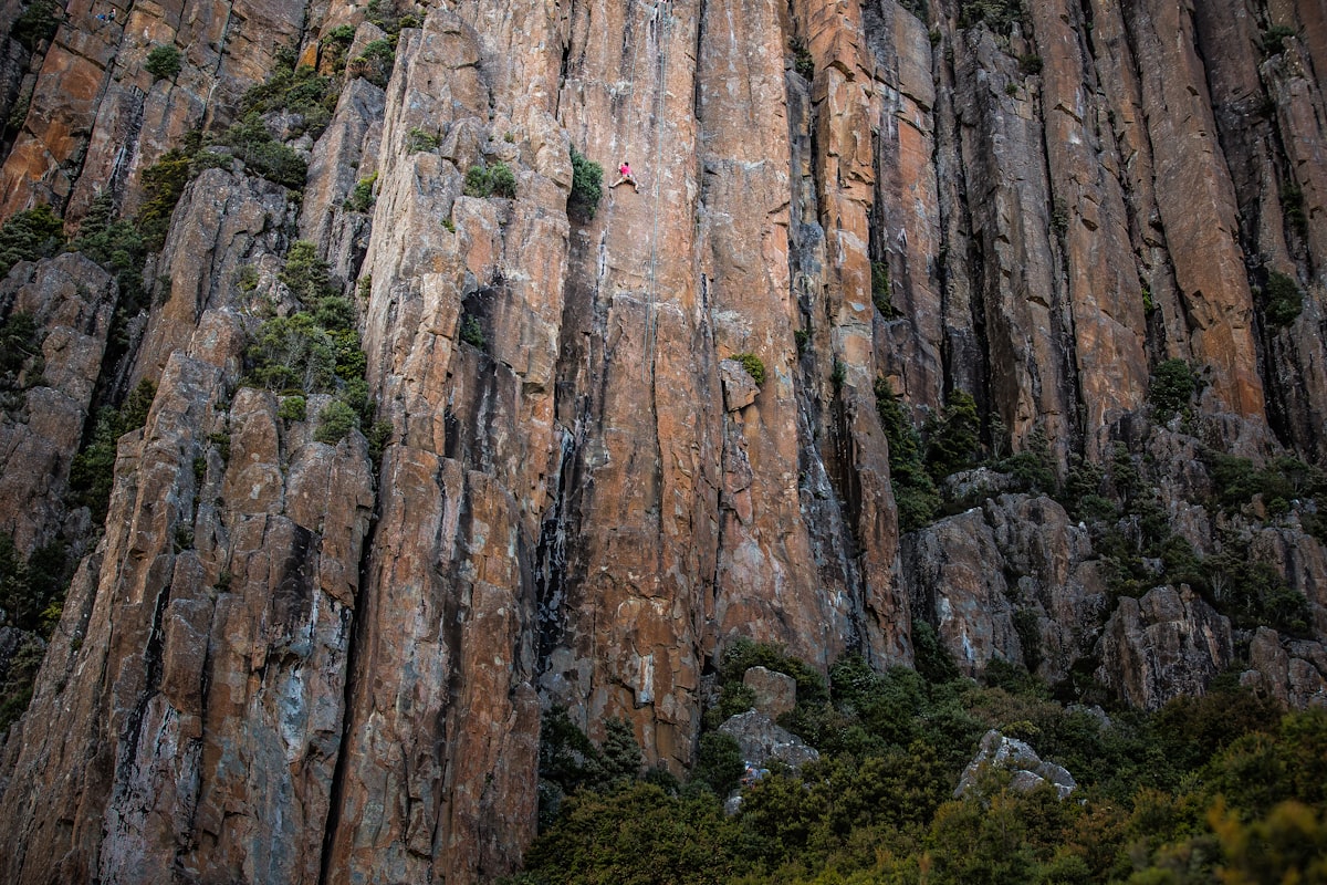 Dramatic vertical rock formations and towering cliff faces along the Tasmanian coastline