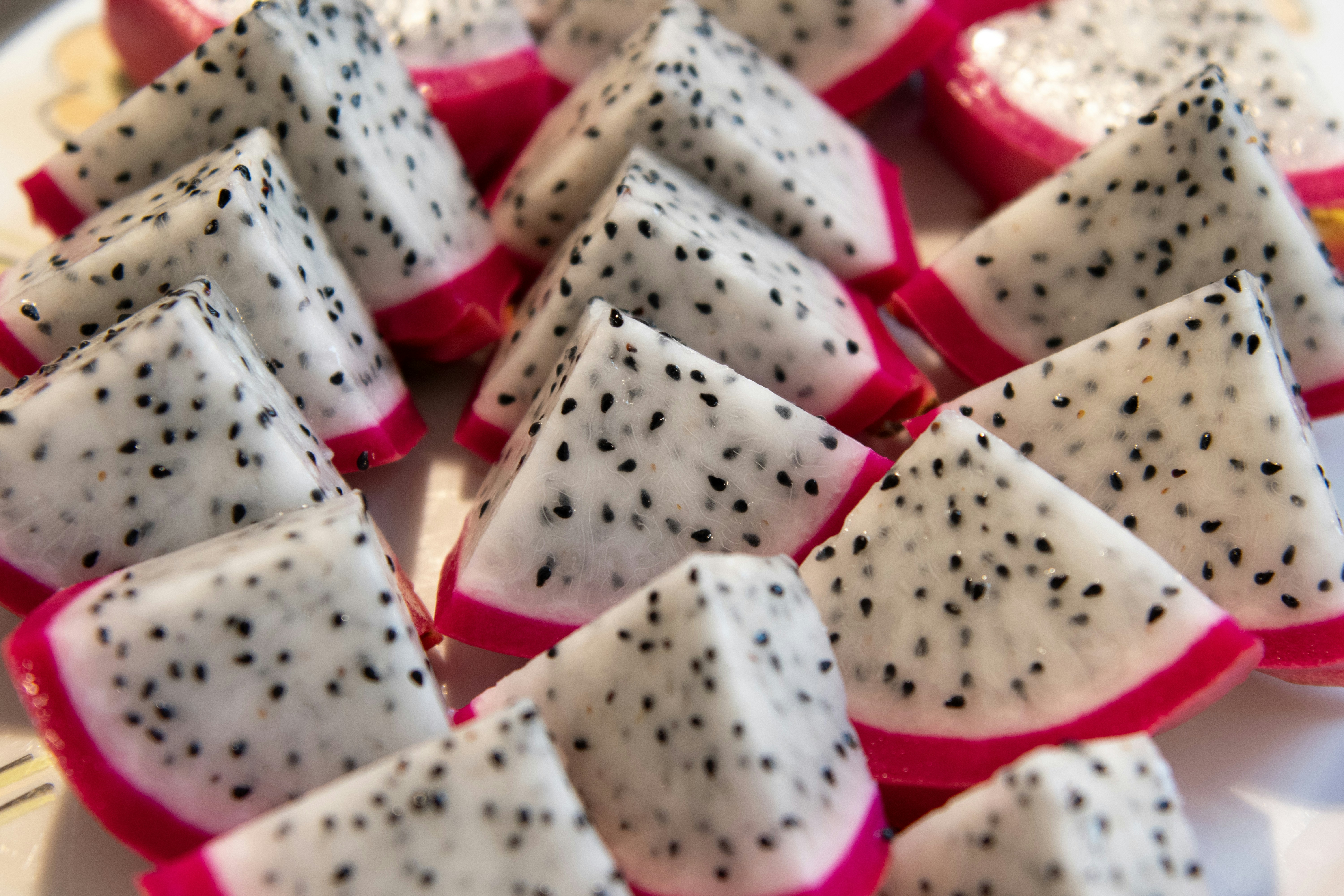 Sliced dragon fruit is displayed, ready to eat.