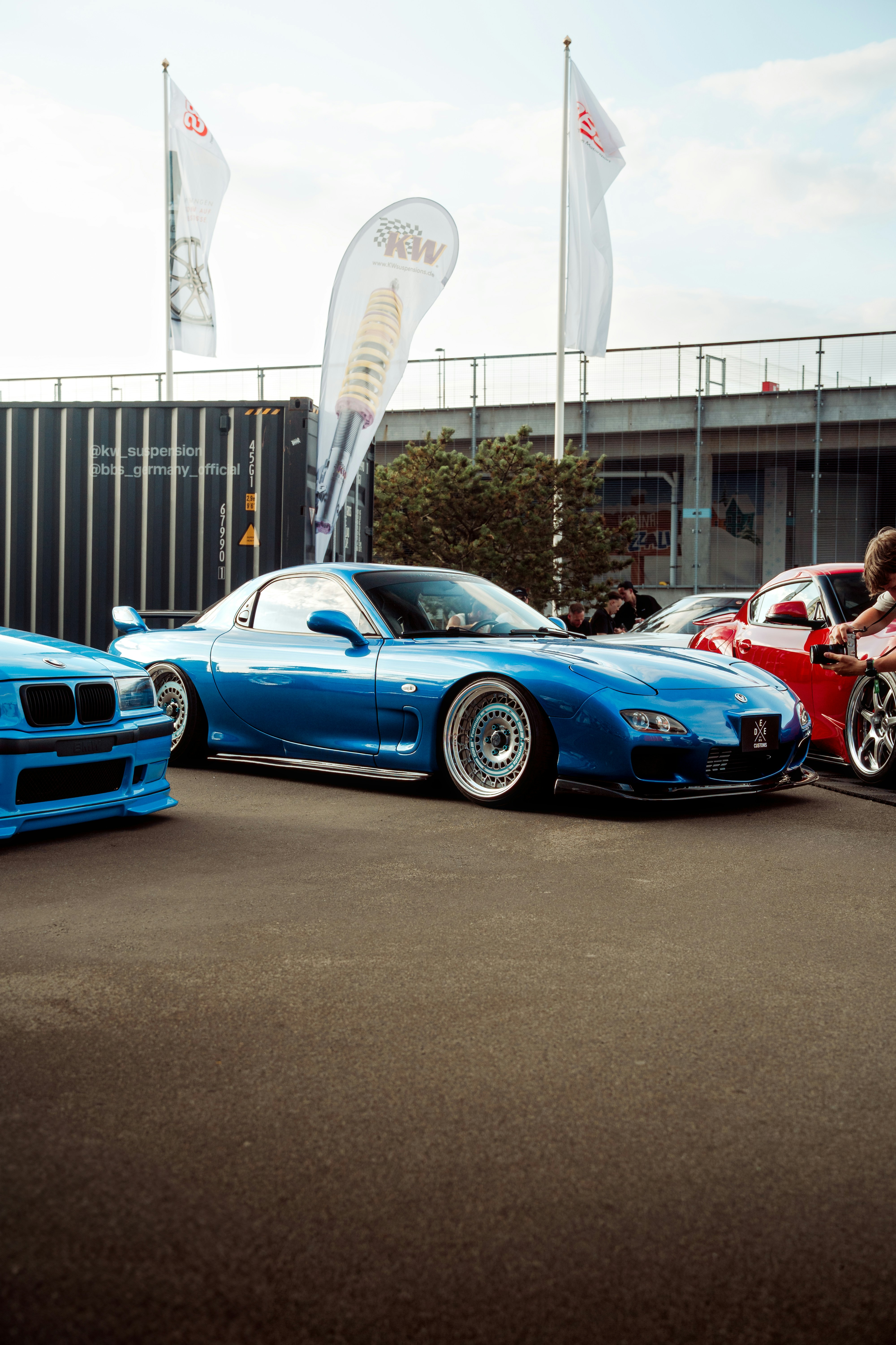 Blue sports car is on display at an event.