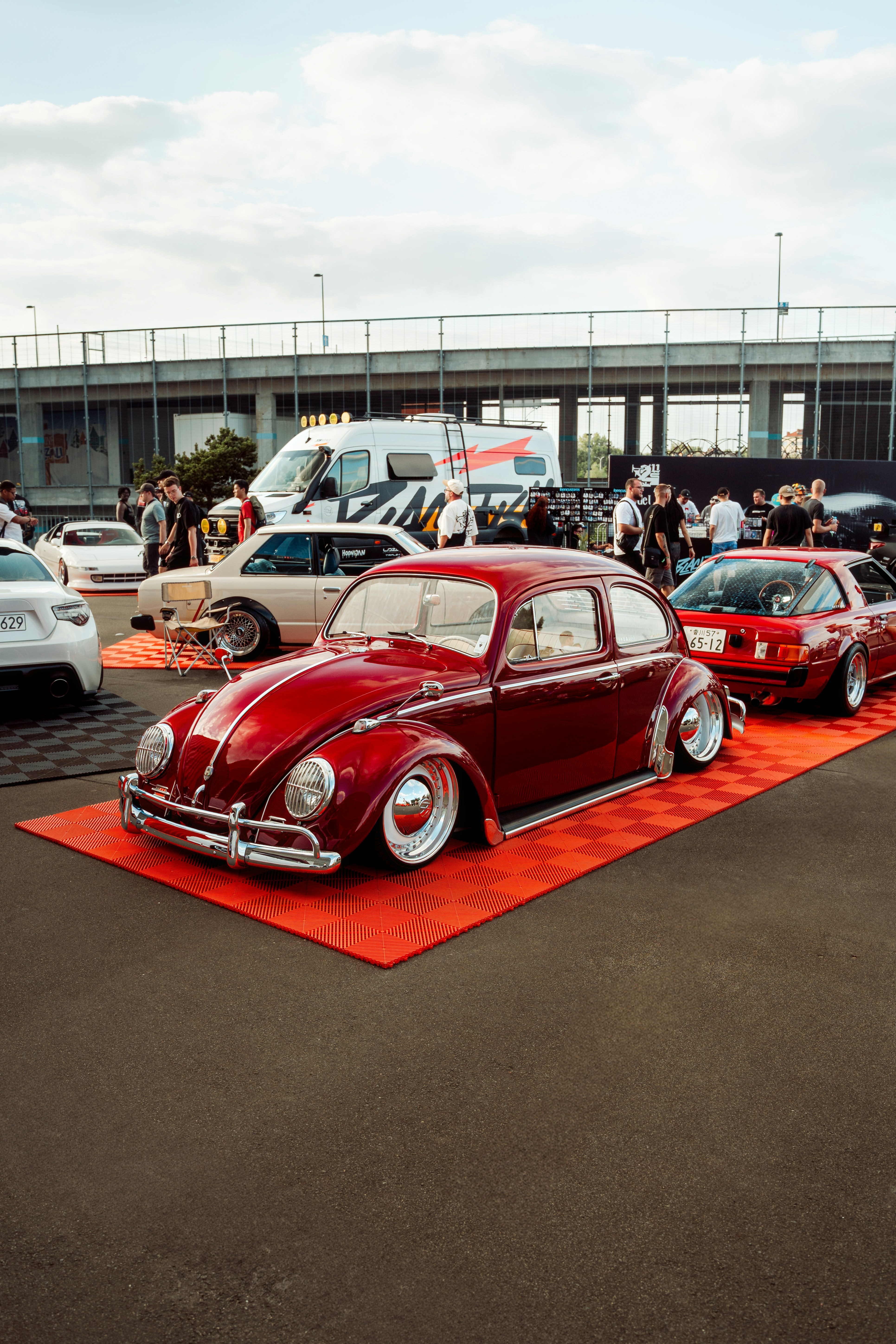 Classic cars are on display at an outdoor event.