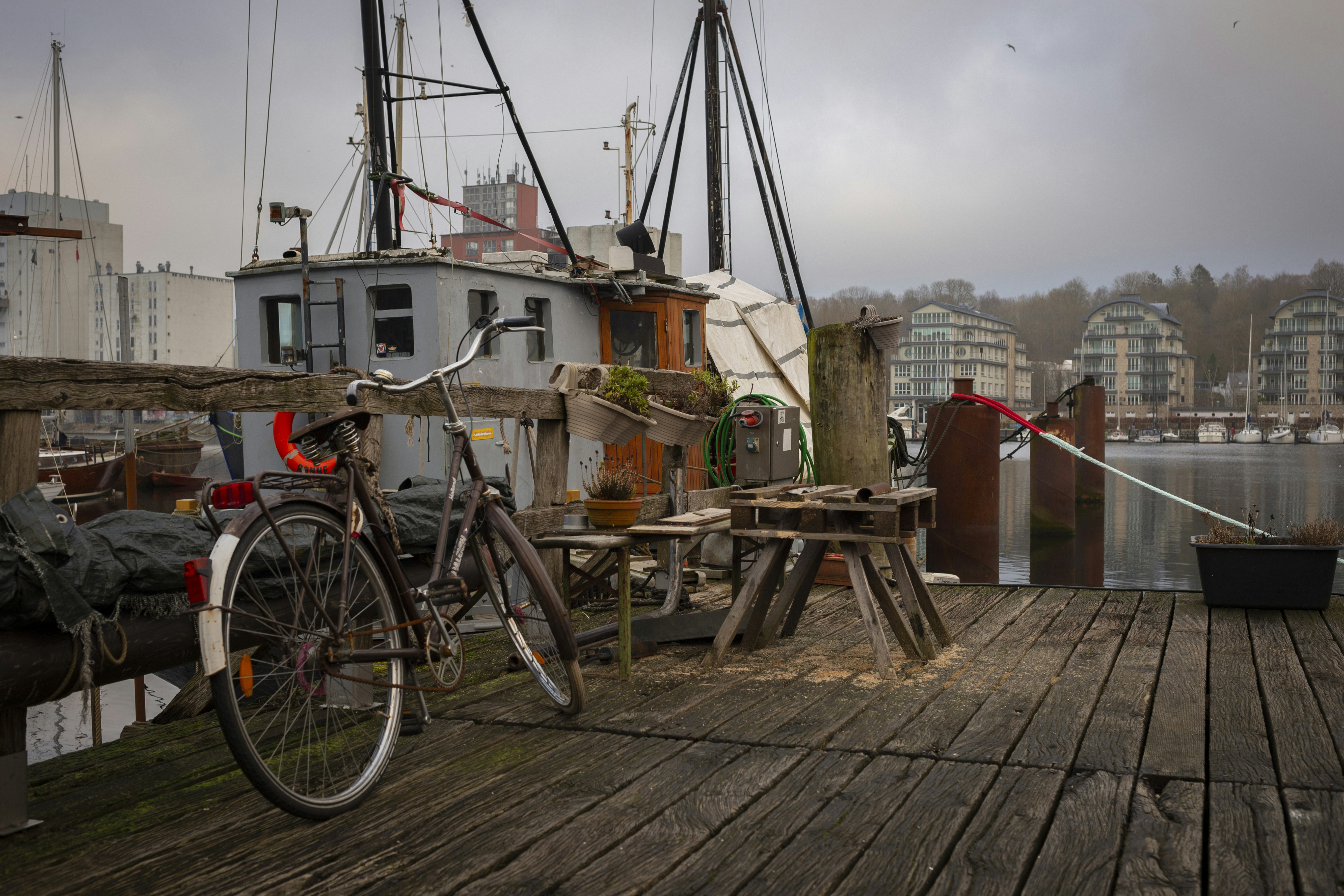 A bicycle rests on a weathered wooden dock.