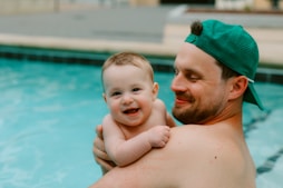 Father and baby enjoy a happy moment in the pool.
