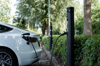 An electric car is charging at a station.