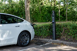 White electric car plugged in at a charging station