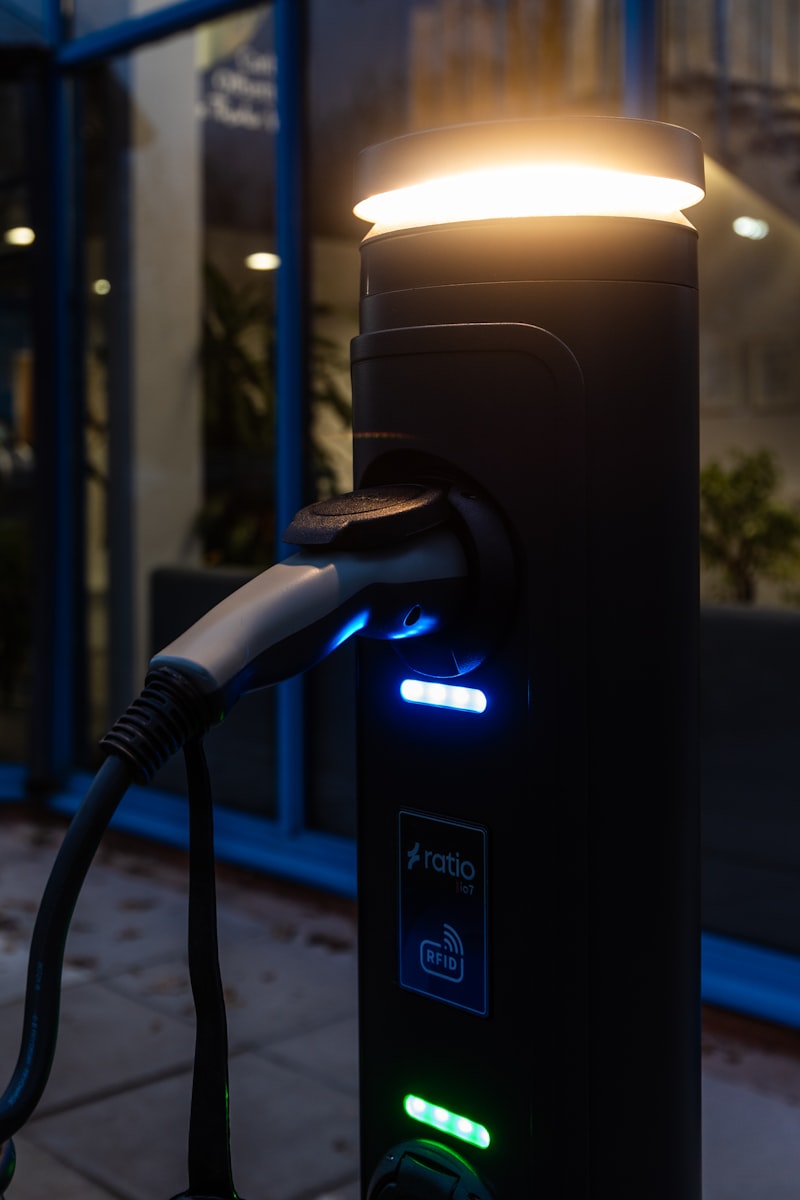 Illuminated EV charging equipment at dusk