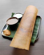Delicious dosa with chutneys, ready to be eaten.