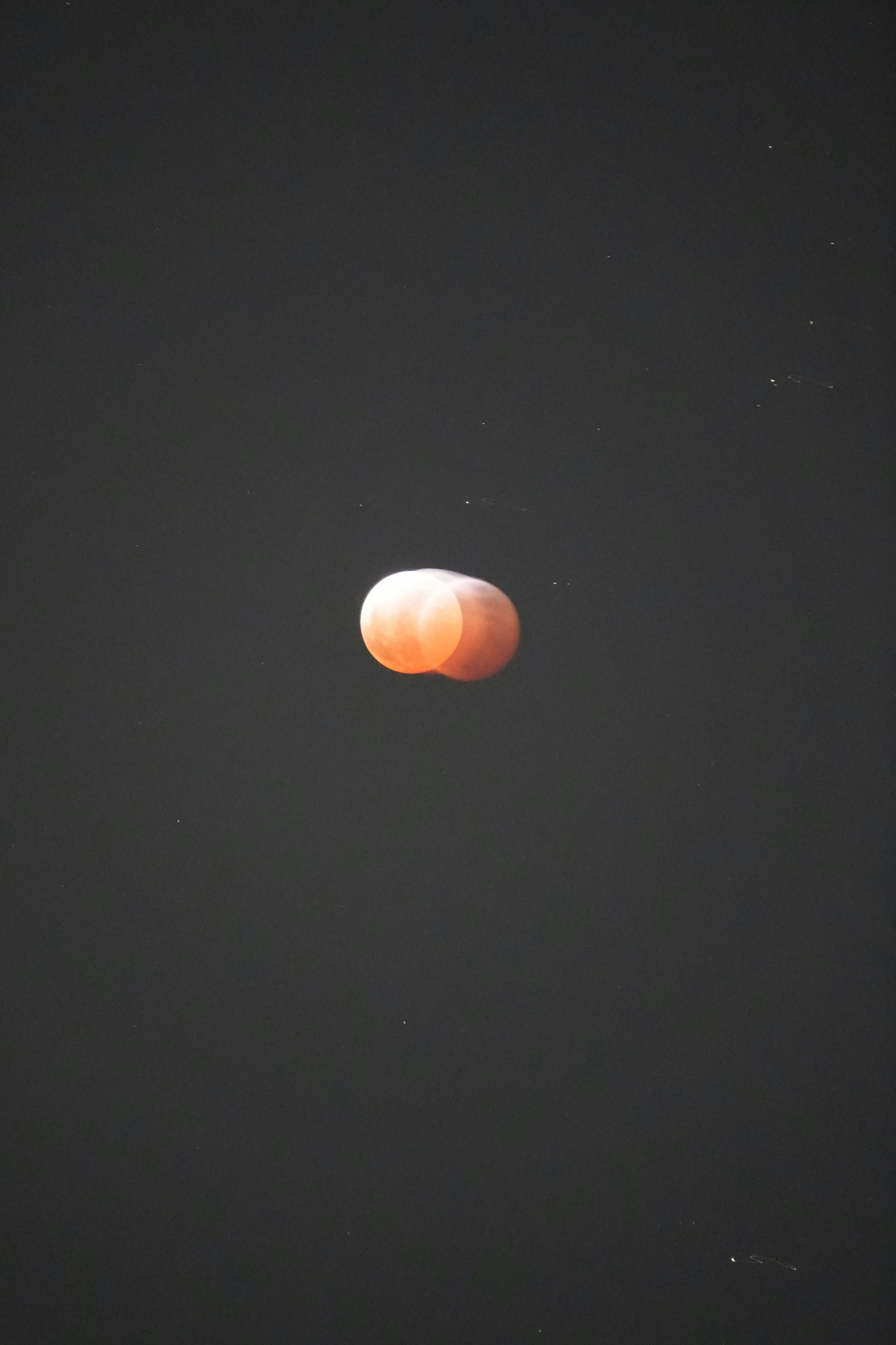 The moon appears during a lunar eclipse.