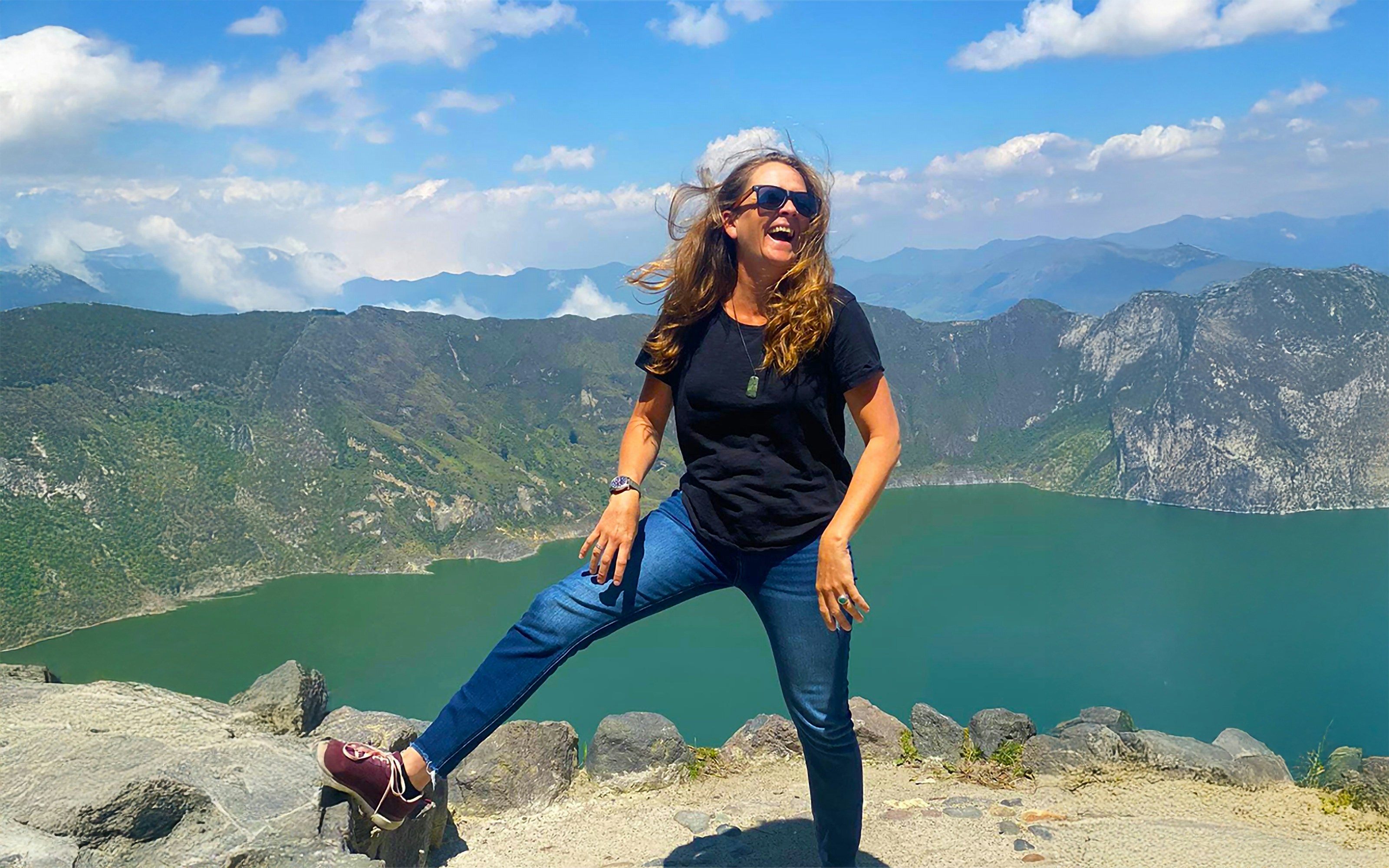 Woman poses with a stunning lake view