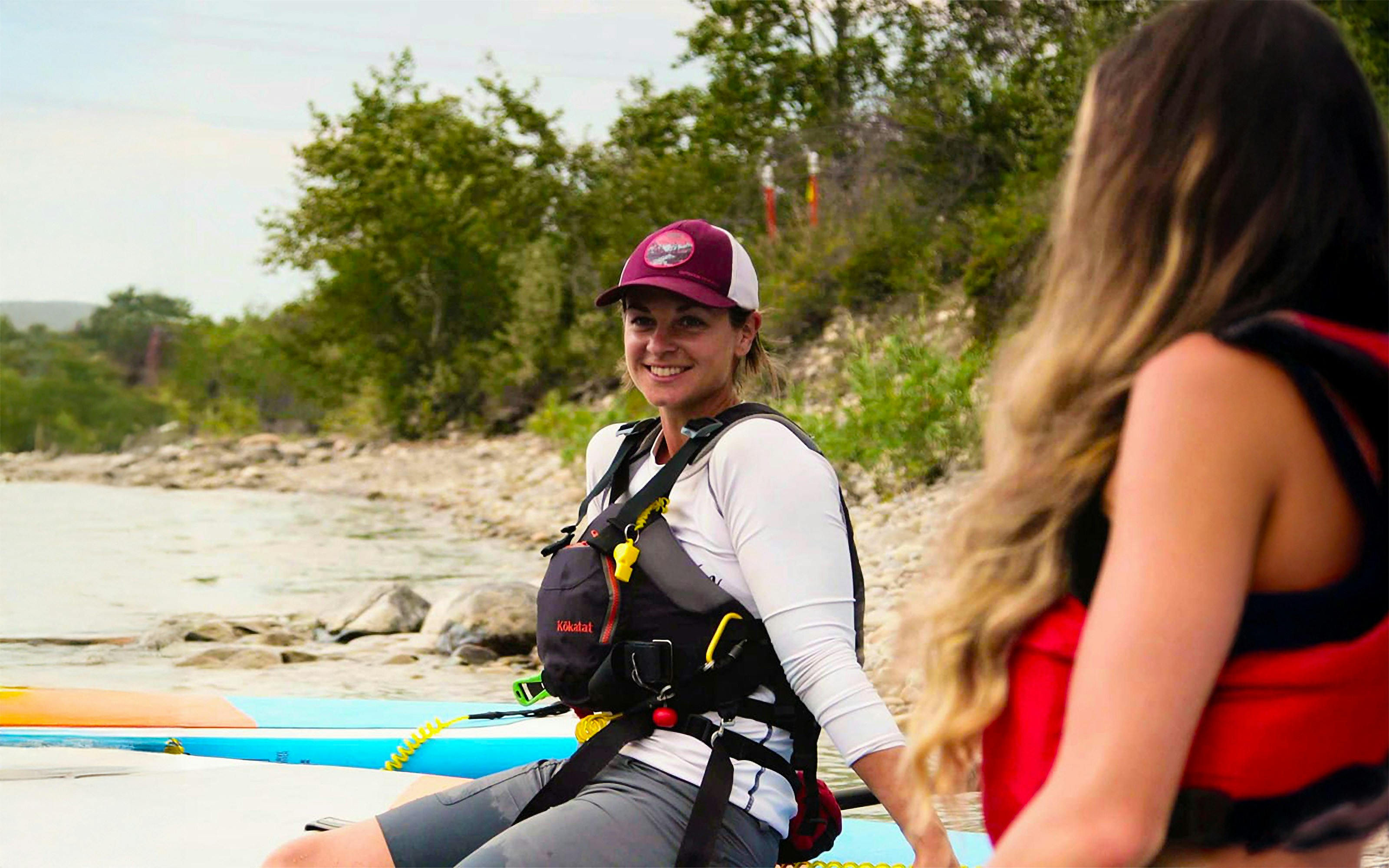 Two women prepare to paddleboard