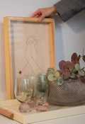 Someone is arranging a decorative tray with items.