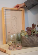 Someone is arranging a decorative tray with items.