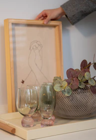 Someone is arranging a decorative tray with items.