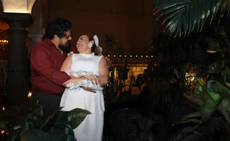 A couple embraces each other happily.