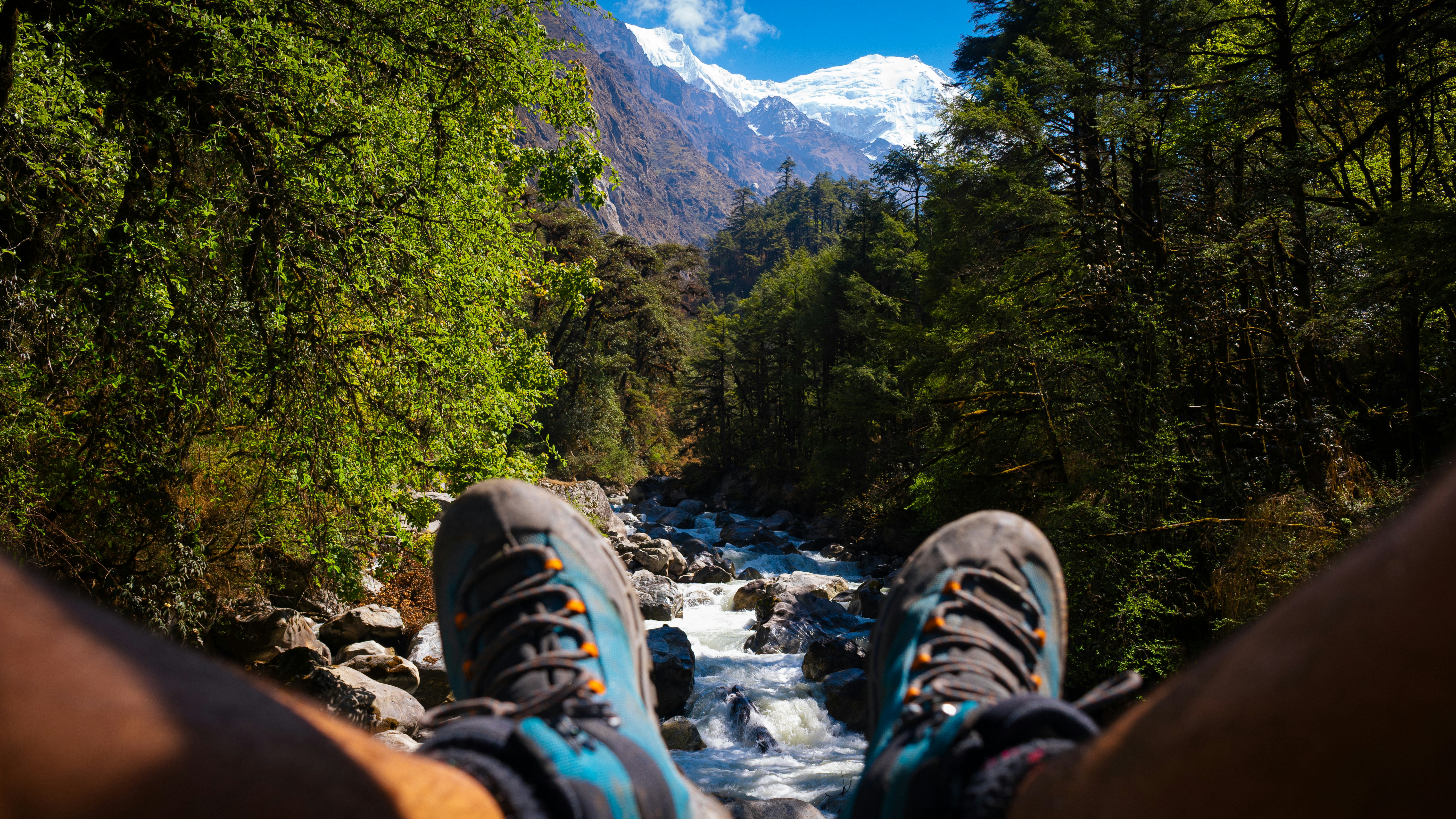 Feet resting, looking at a mountain and river.