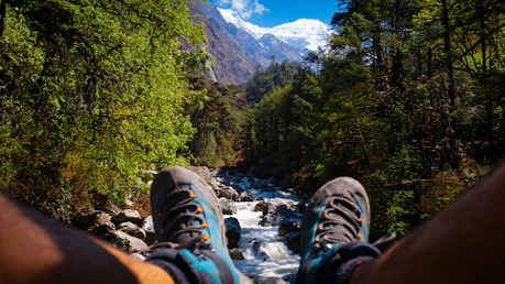 Feet resting, looking at a mountain and river.