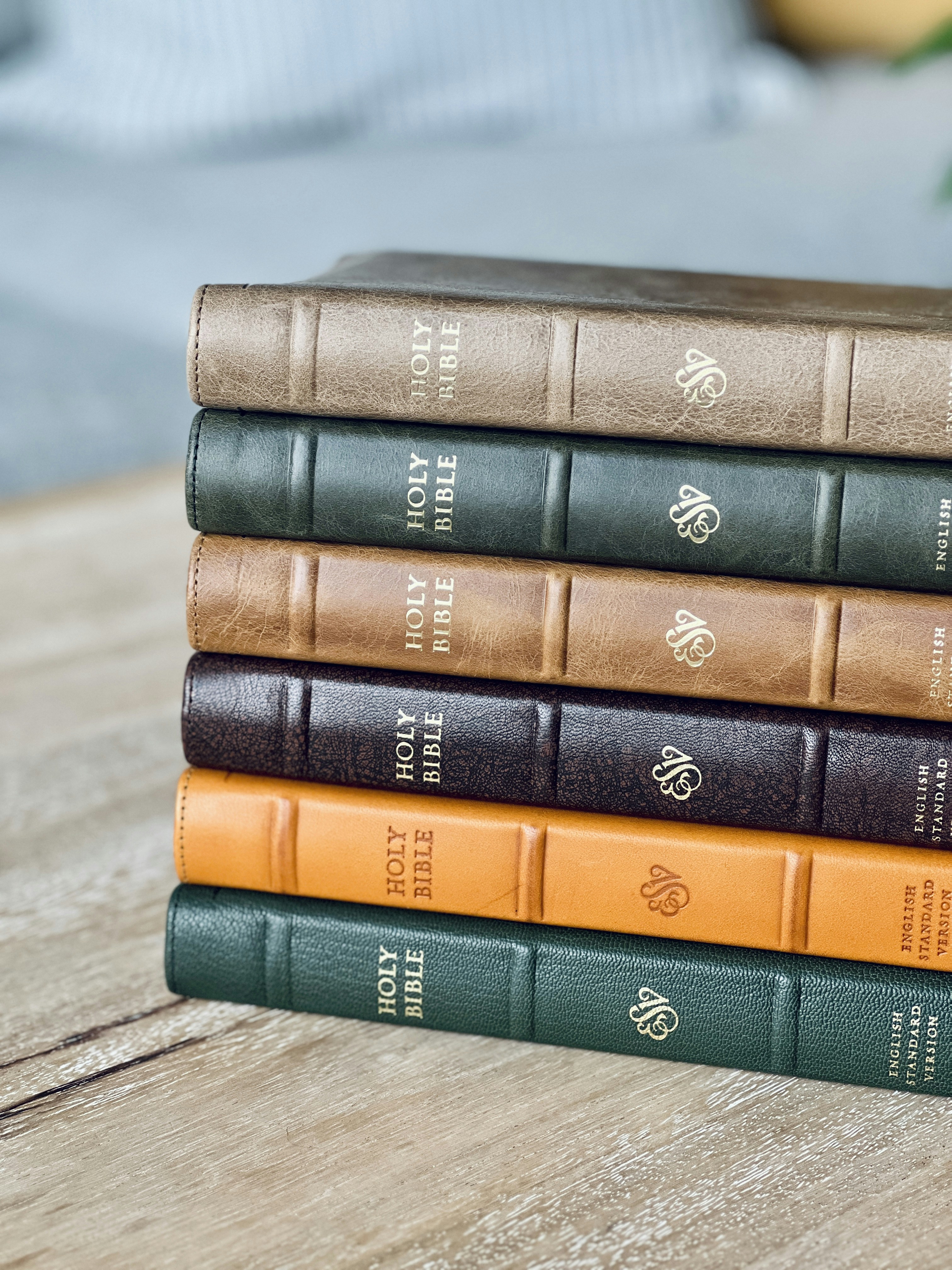 A stack of holy bibles rests on wood.