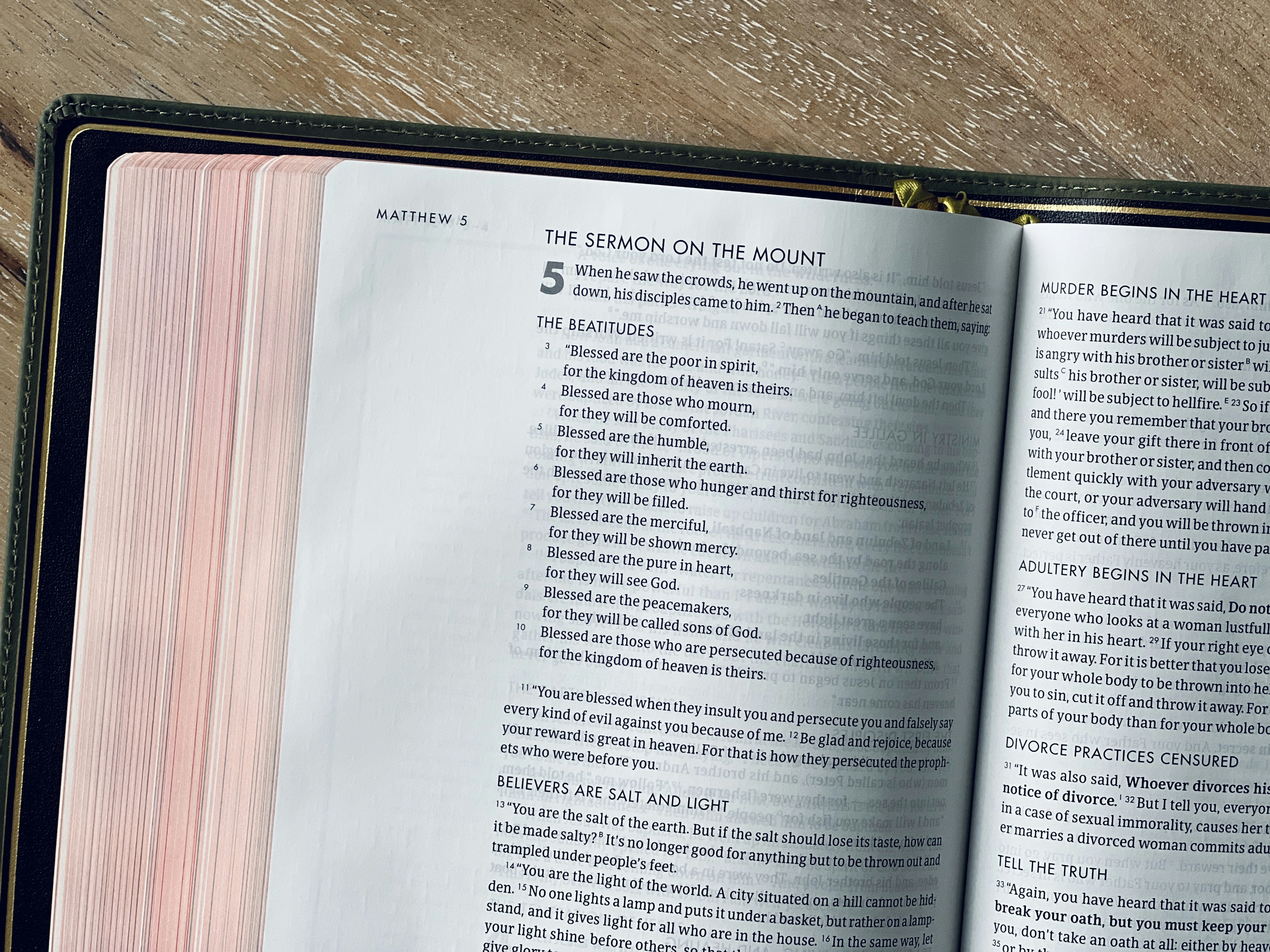 An open bible displays the sermon on the mount.