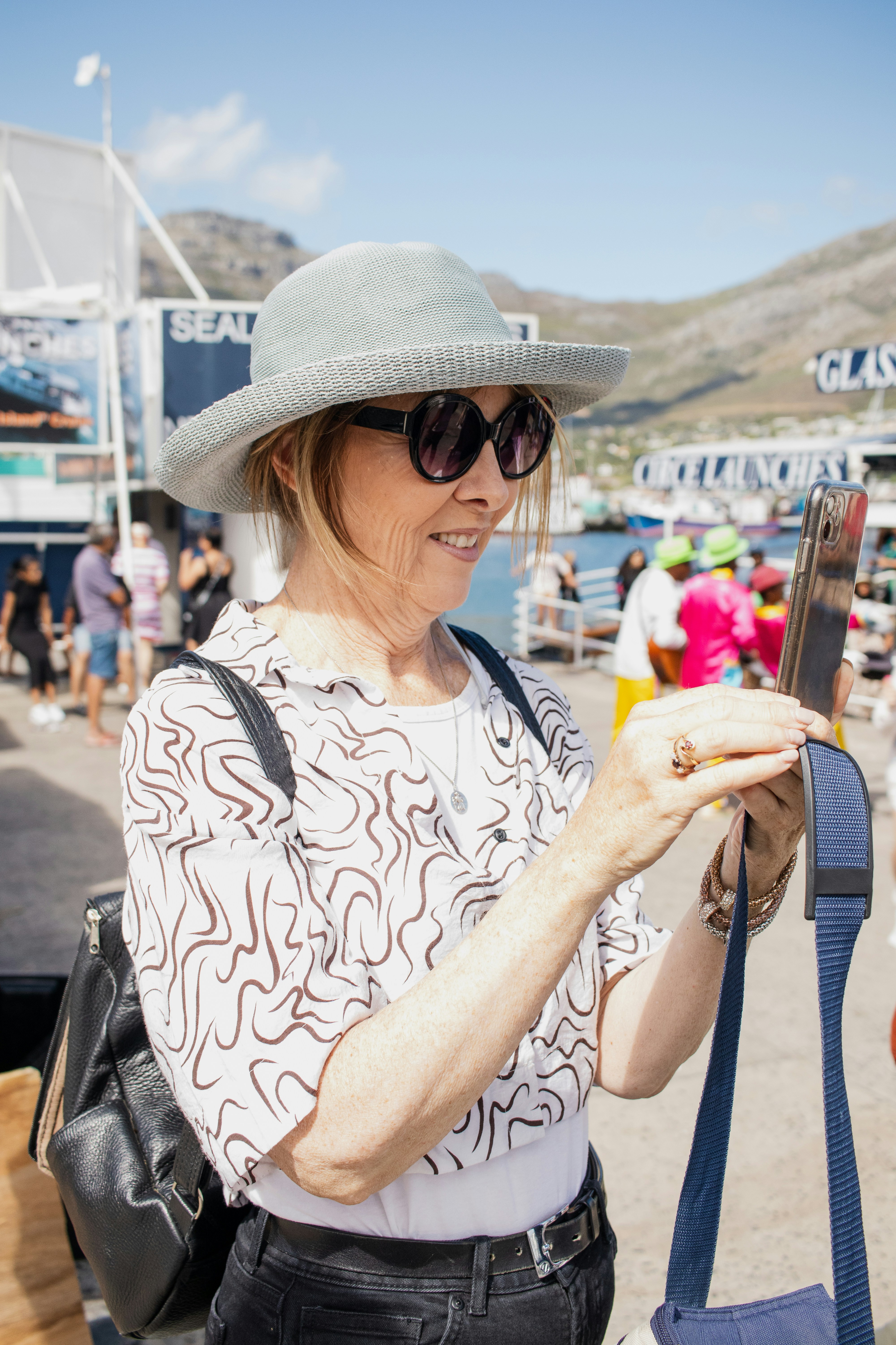 A woman takes a photo outside