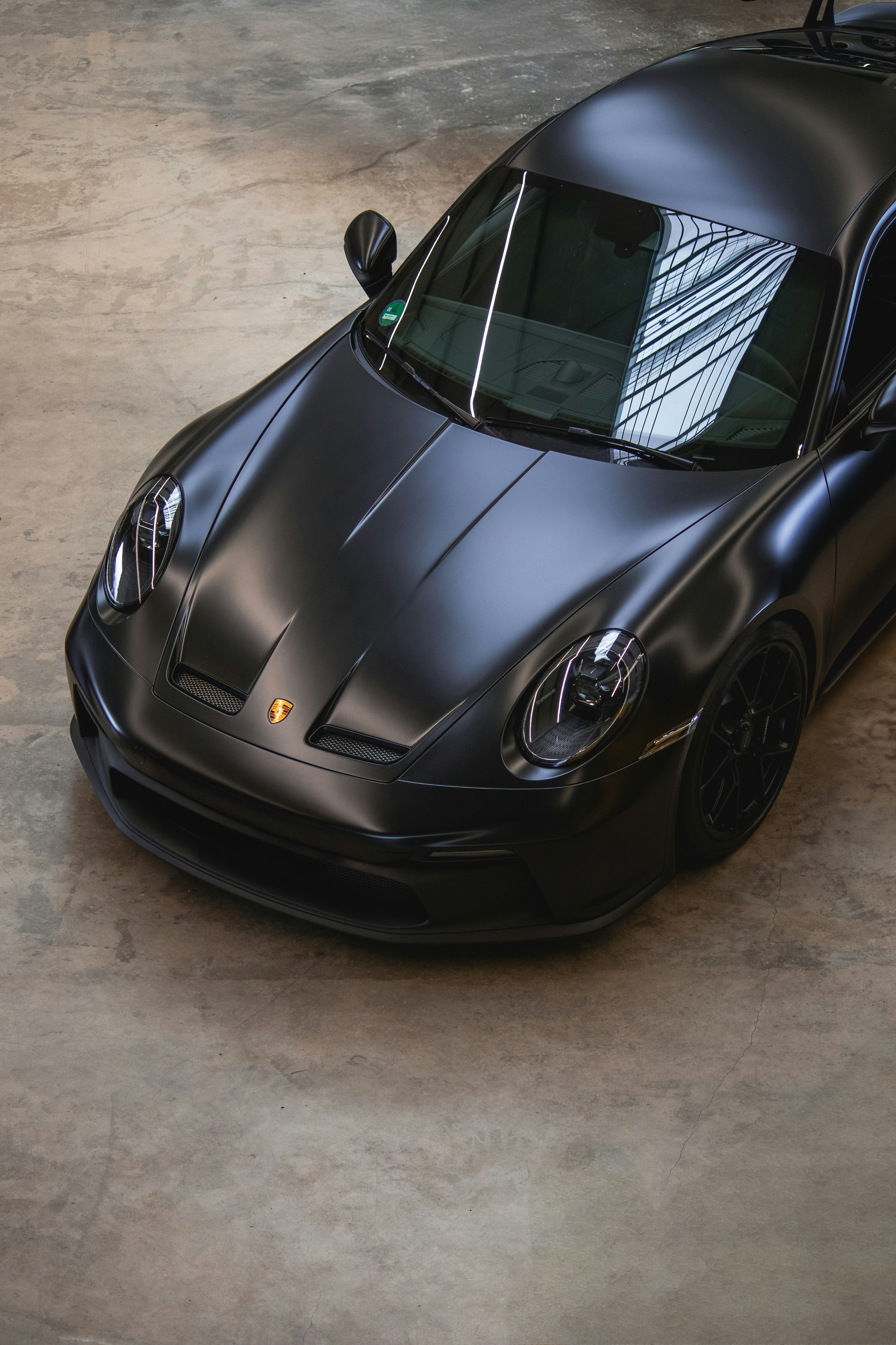 A sleek, black porsche is displayed.