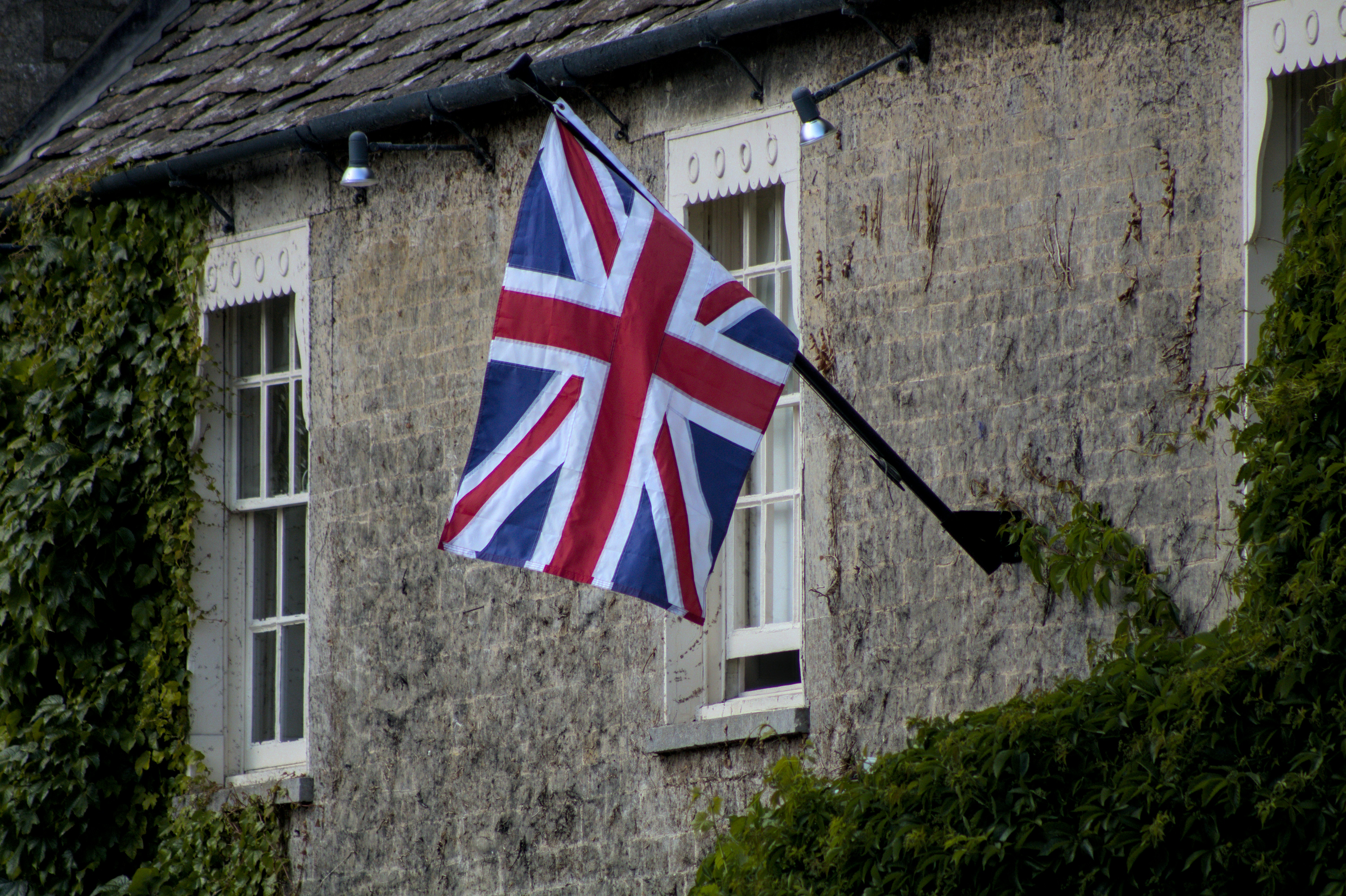 The union jack flies outside a building.