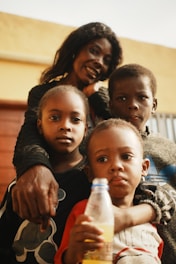 A mother poses with her three children.