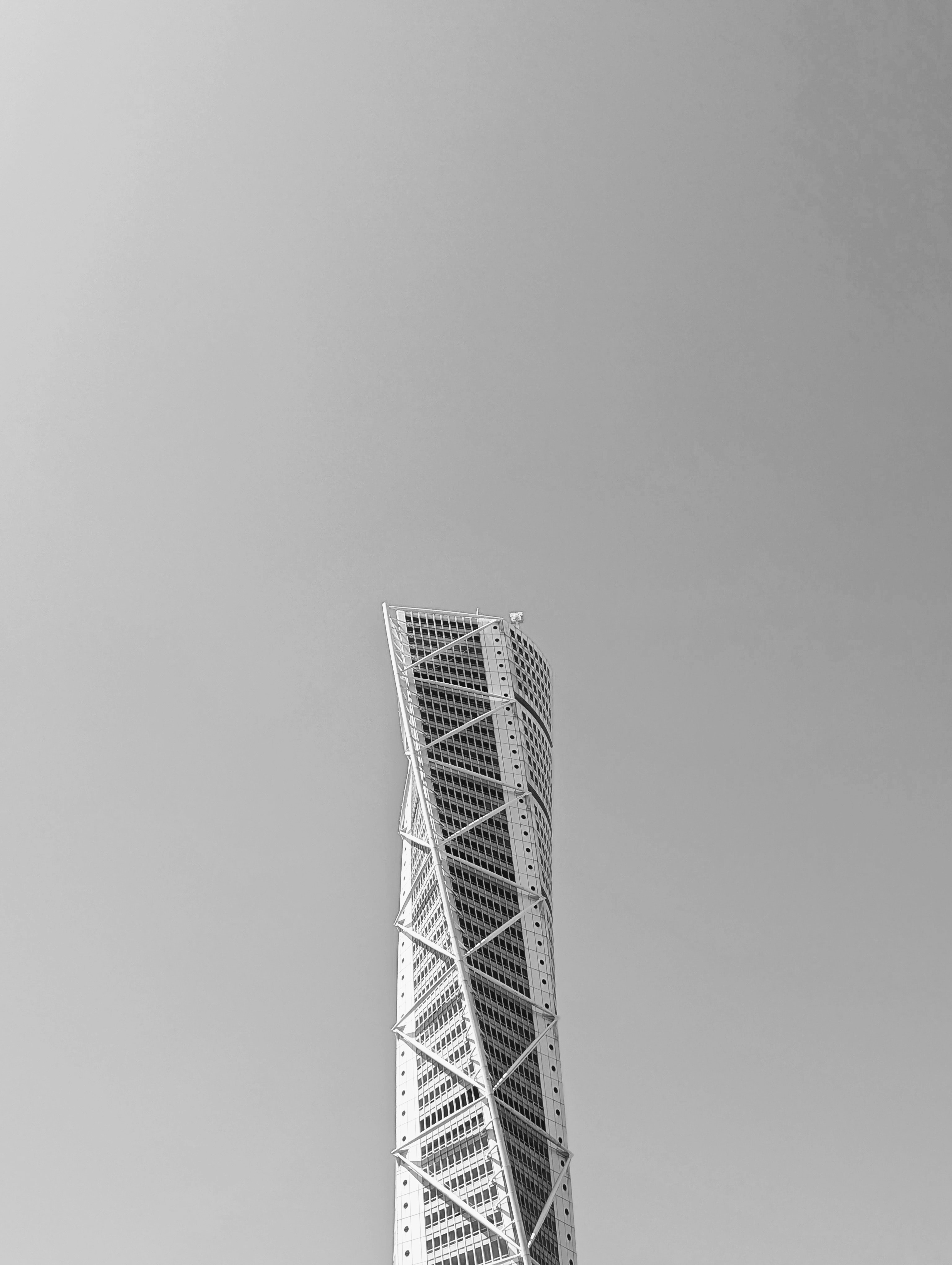 Twisted skyscraper against a clear, gray sky.