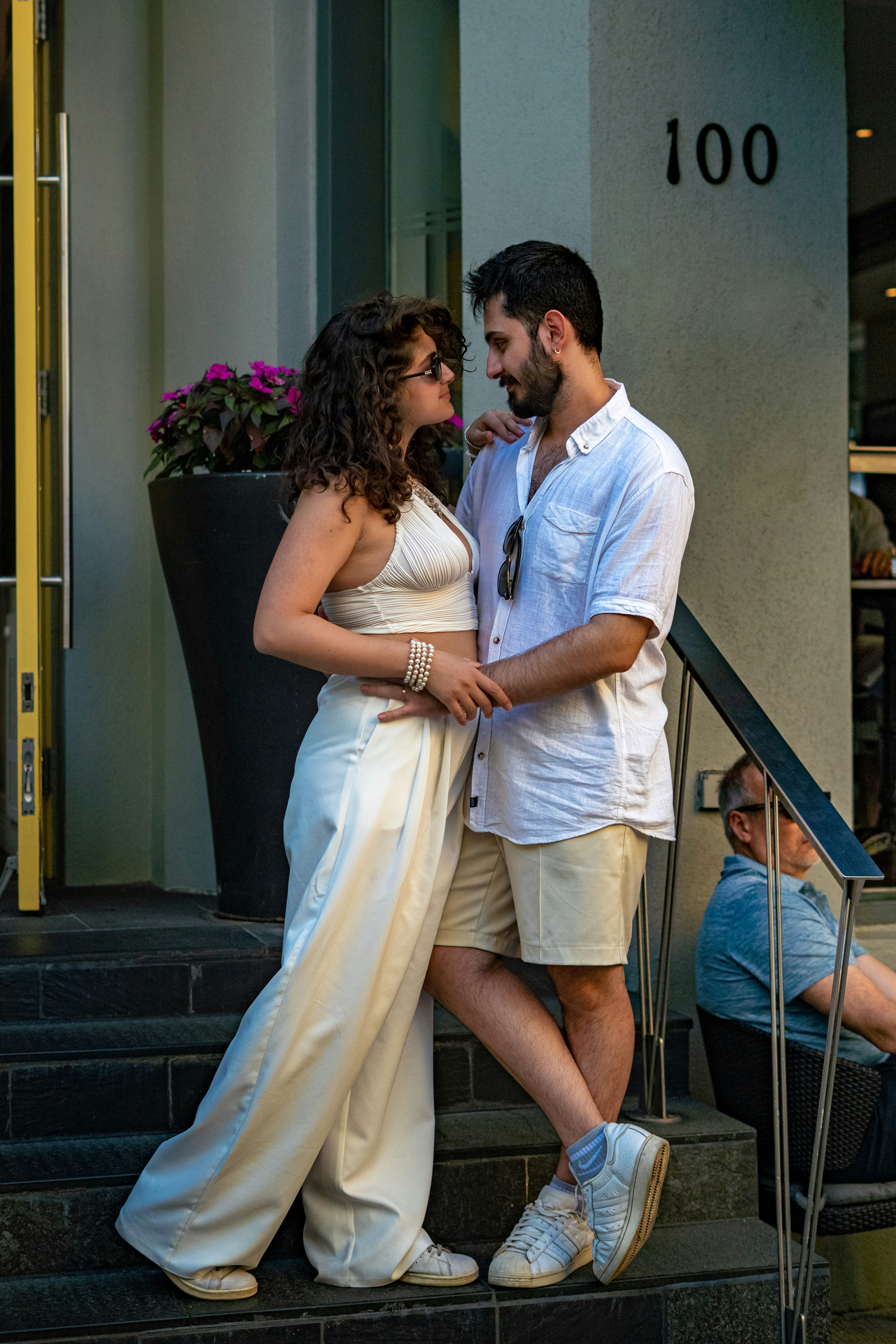 A couple lovingly poses on some steps.