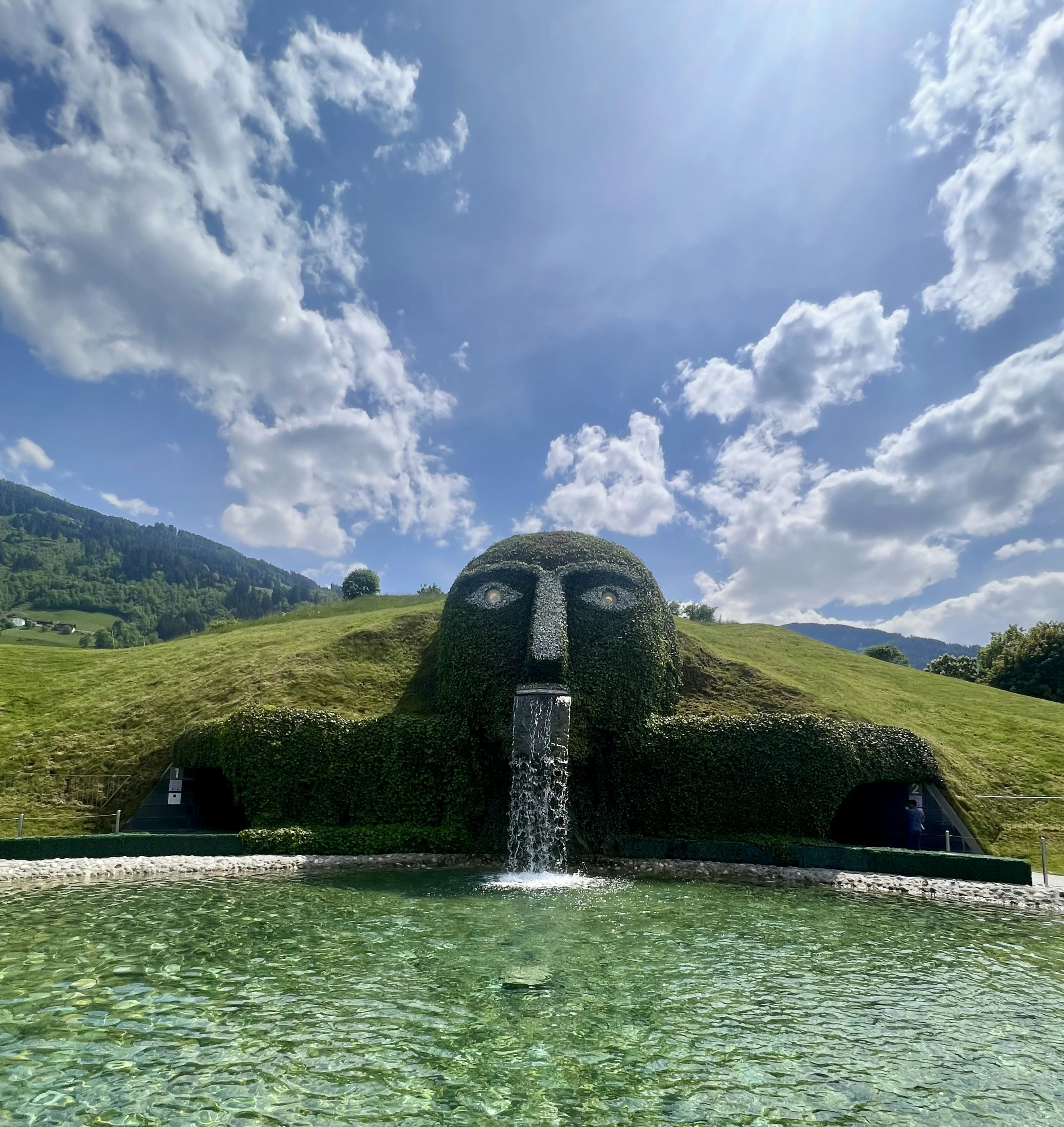 A mountainous face sculpture with a waterfall. photo – Free Blue Image ...