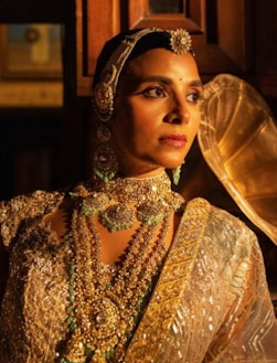 A woman wears beautiful traditional indian jewelry.